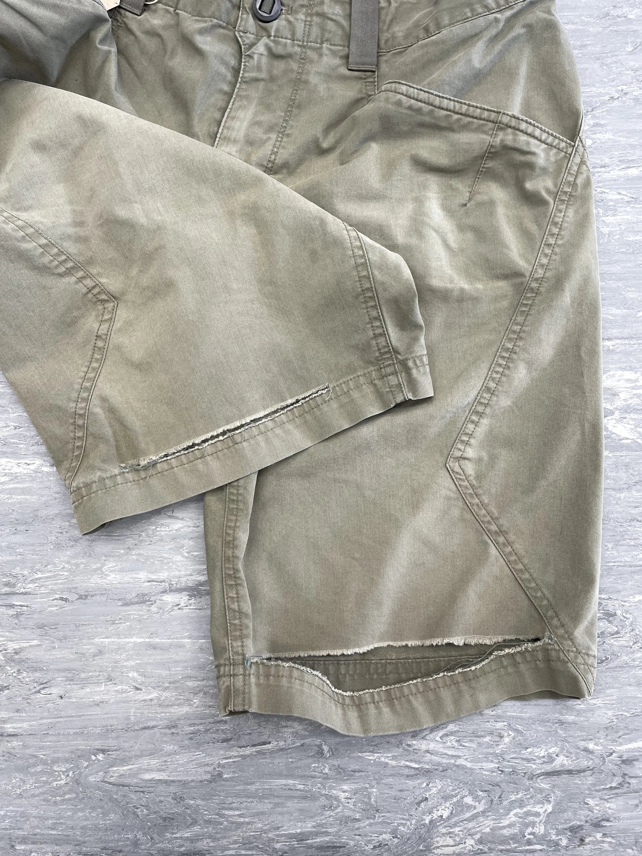 Tear above hem of shorts on both sides