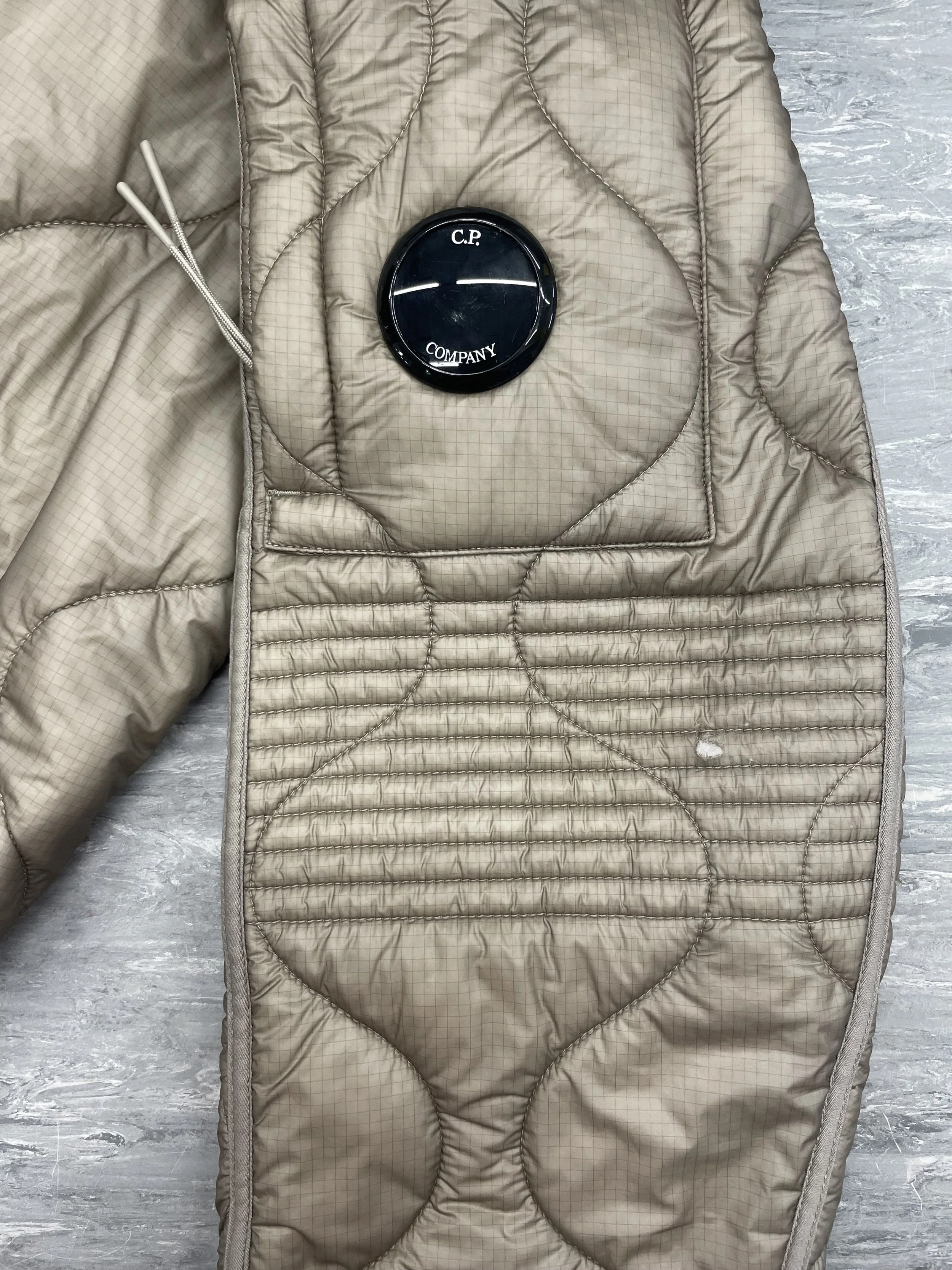 Small hole to sleeve of CP Company coat with loss of down
