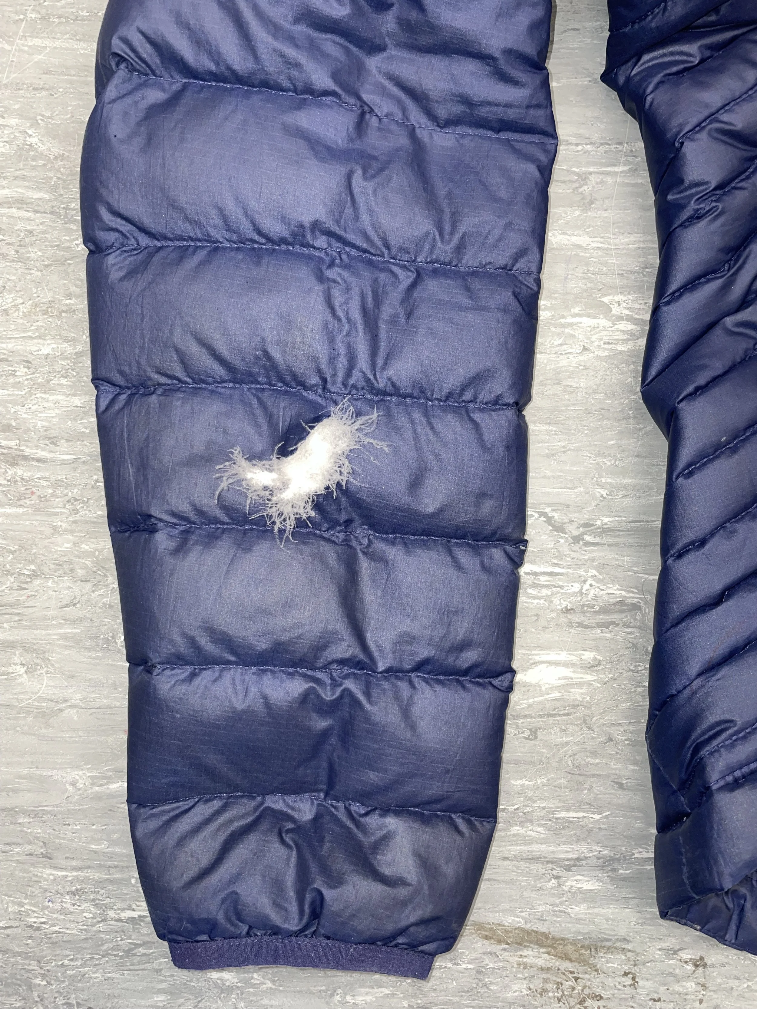 Sleeve hole with loss of down filling on Patagonia coat 