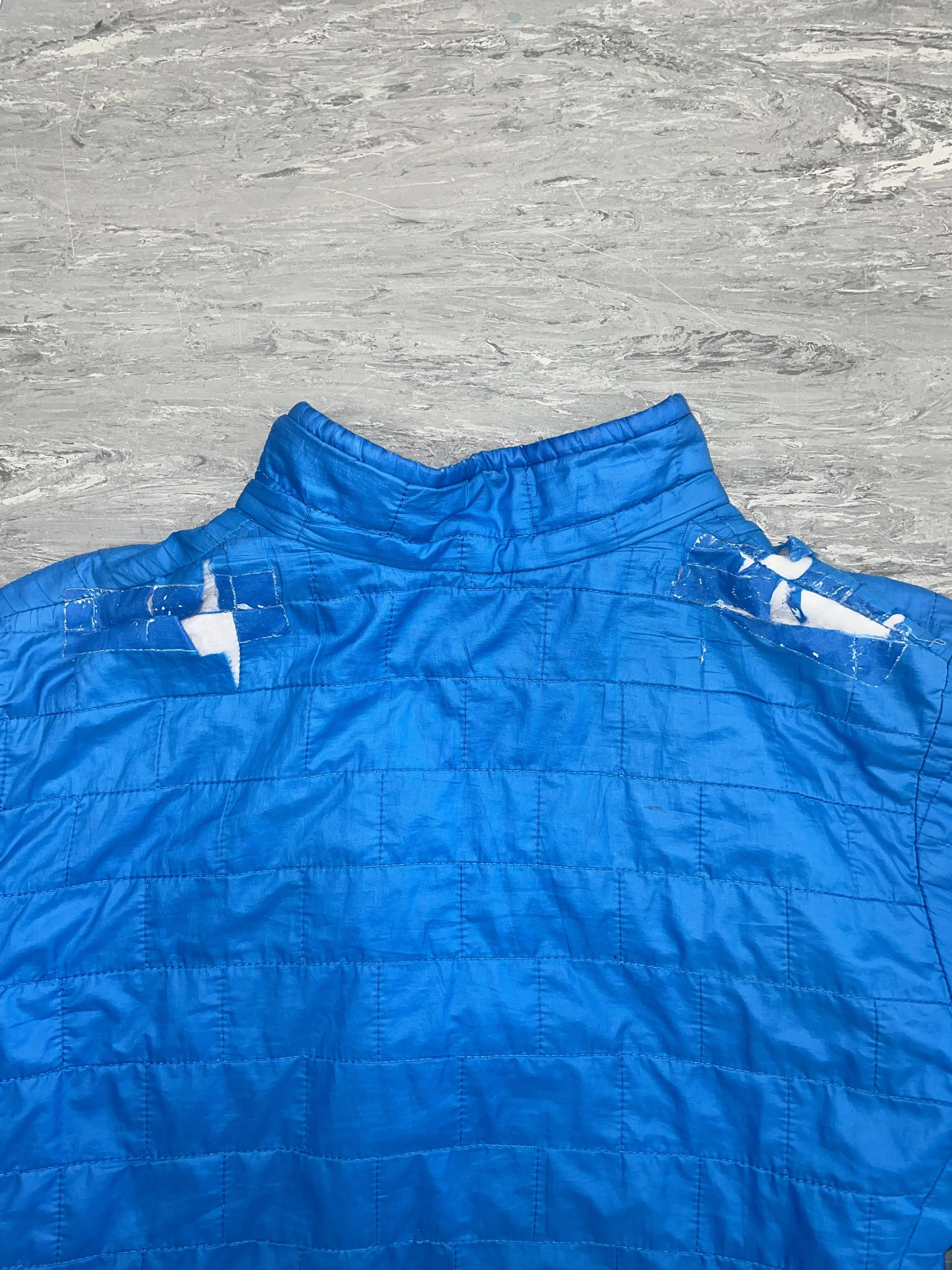Fabric worn away on both shoulders