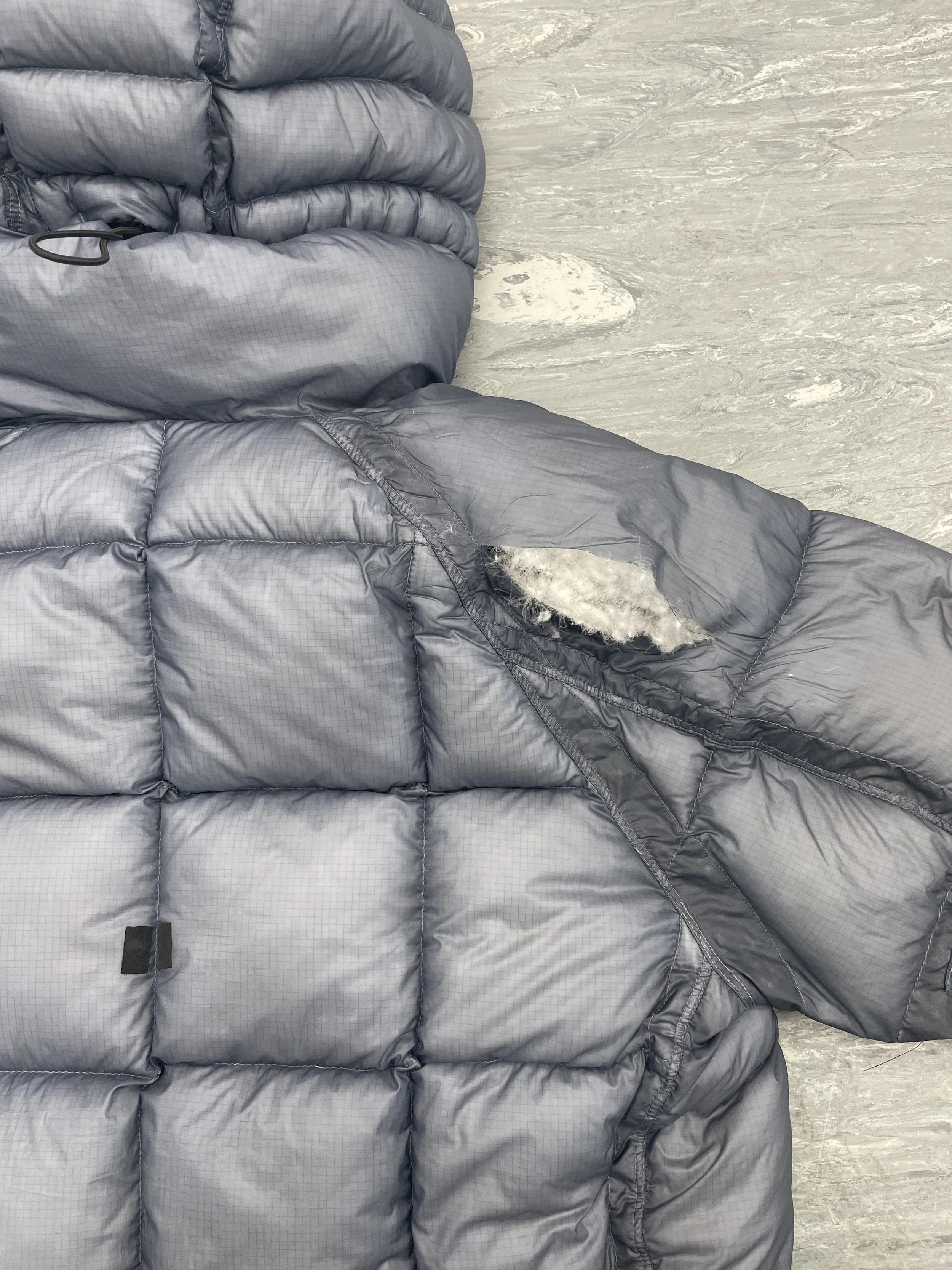 Rip on shoulder of down coat