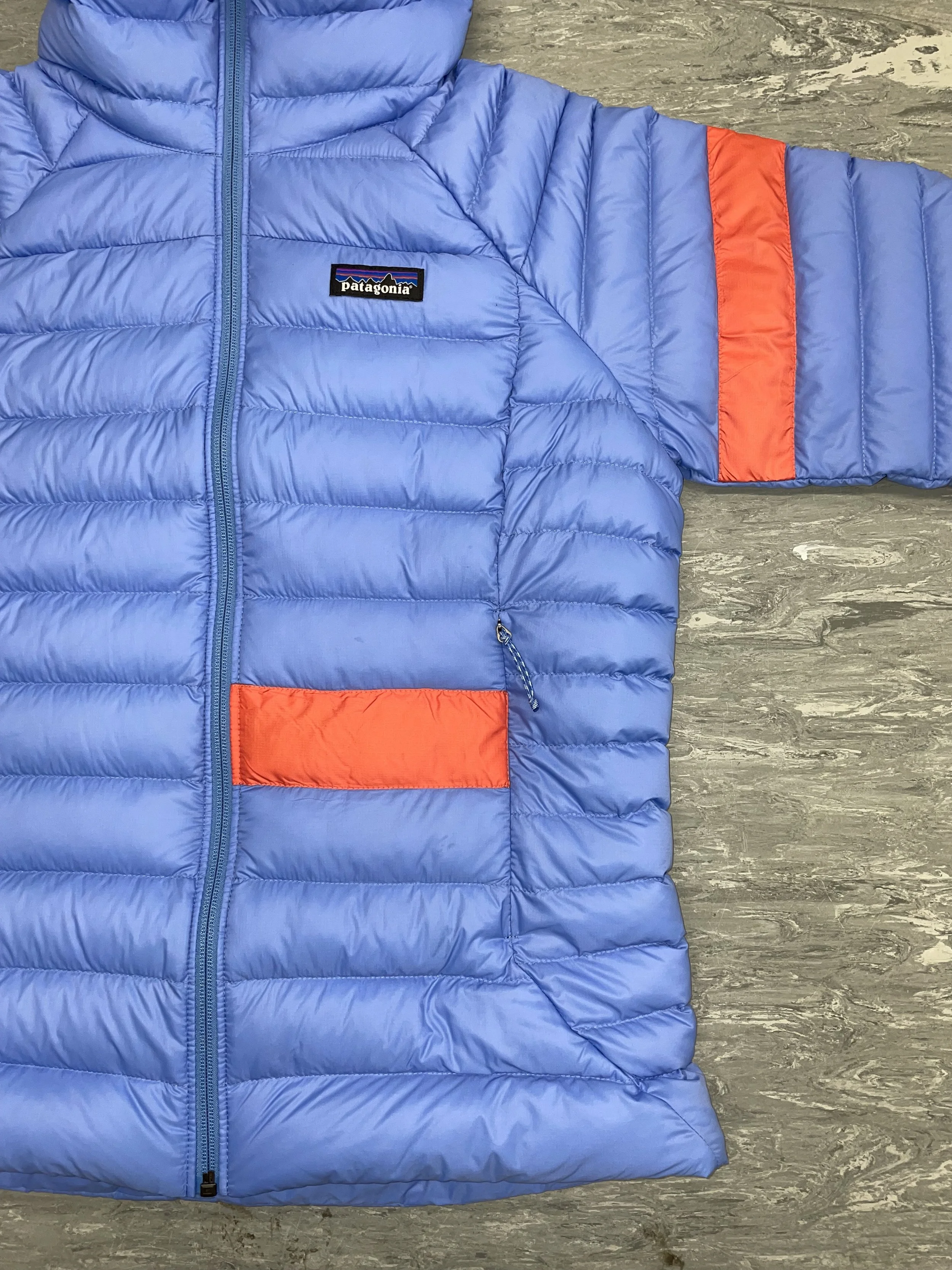 Contrasting panel repairs applied to cover damage and reinforce the garment 