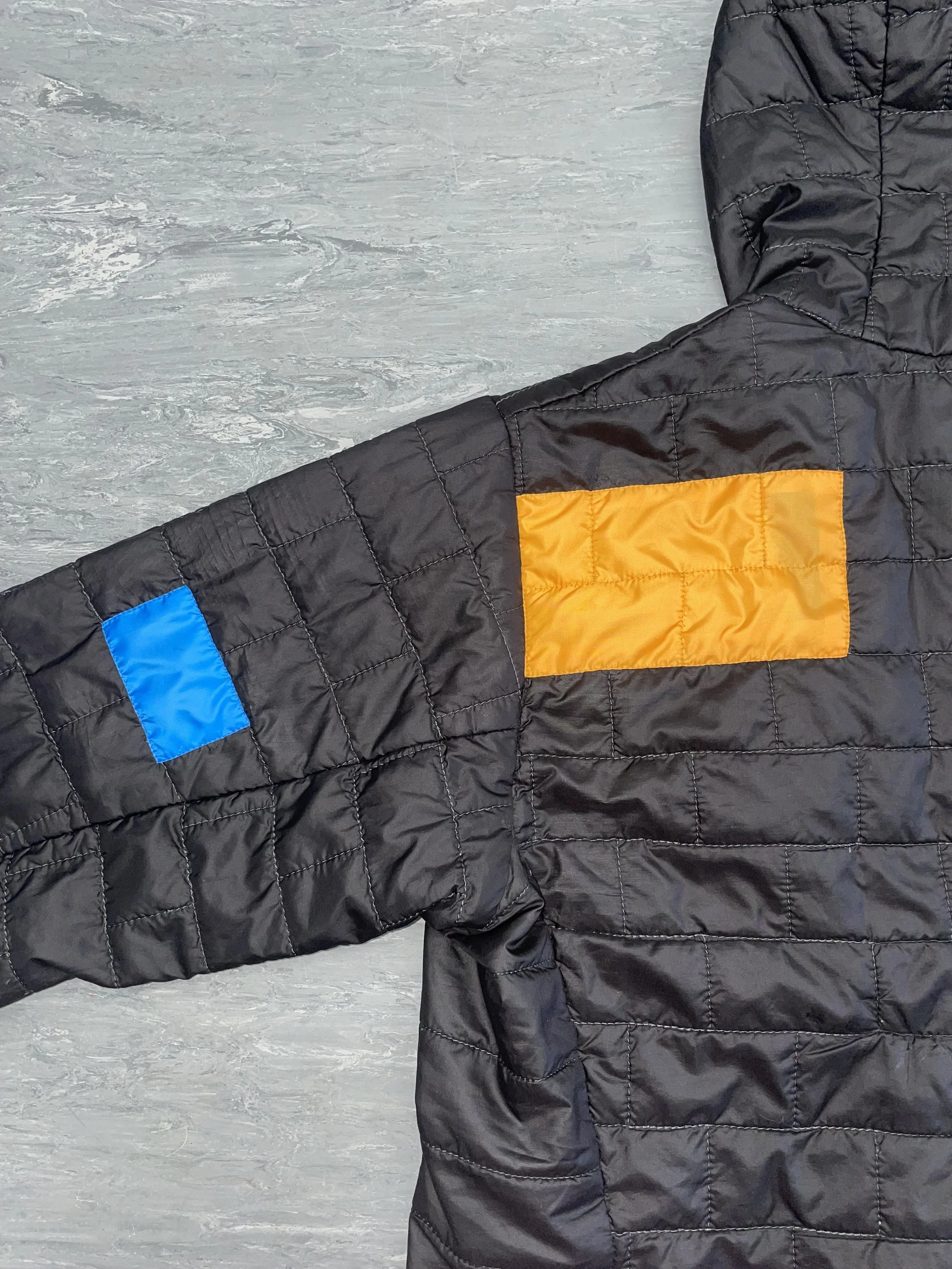 Contrasting patch repairs applied with down refilled to restore insulation