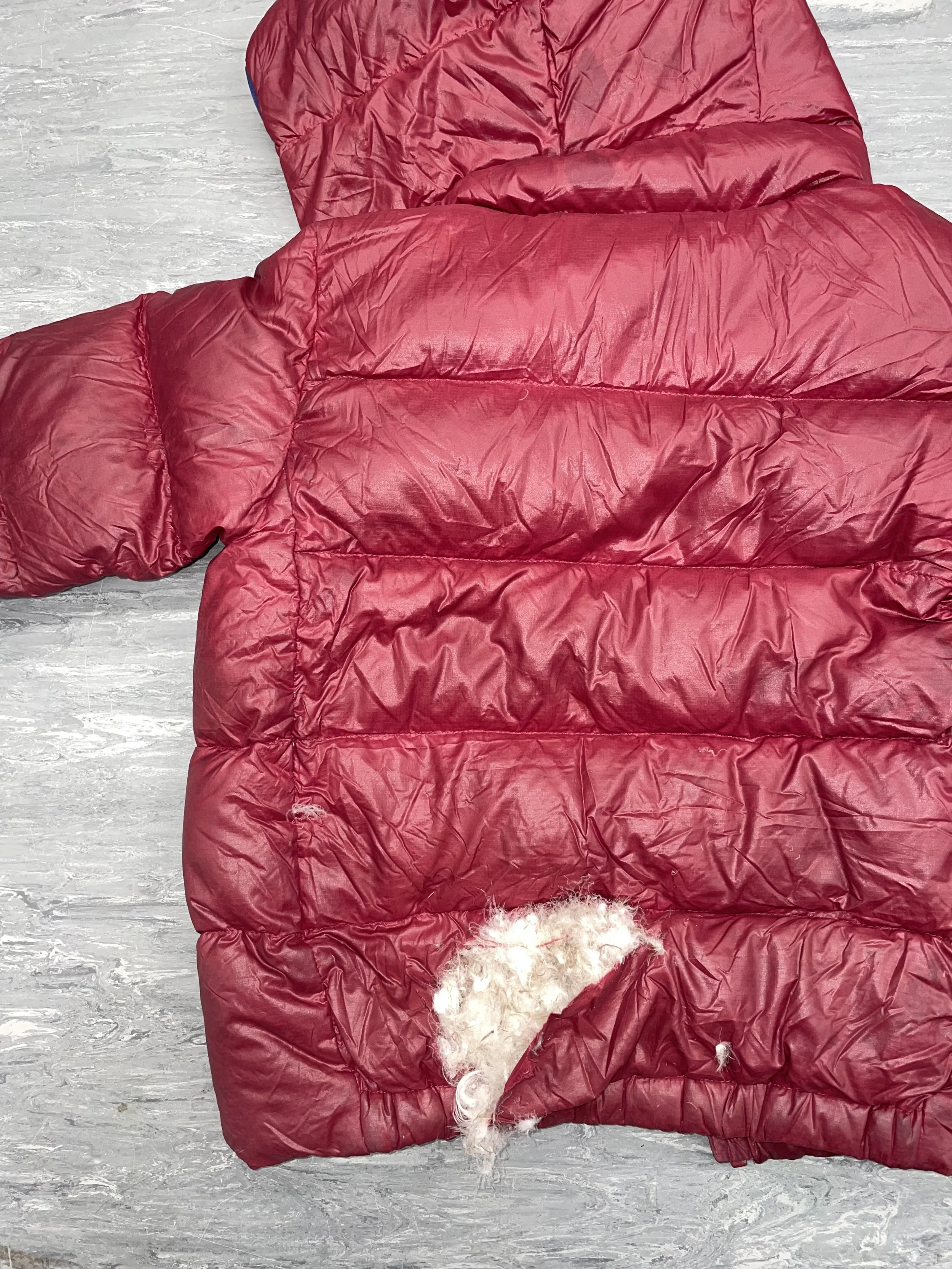 Large tear in Patagonia down coat with significant loss of filling