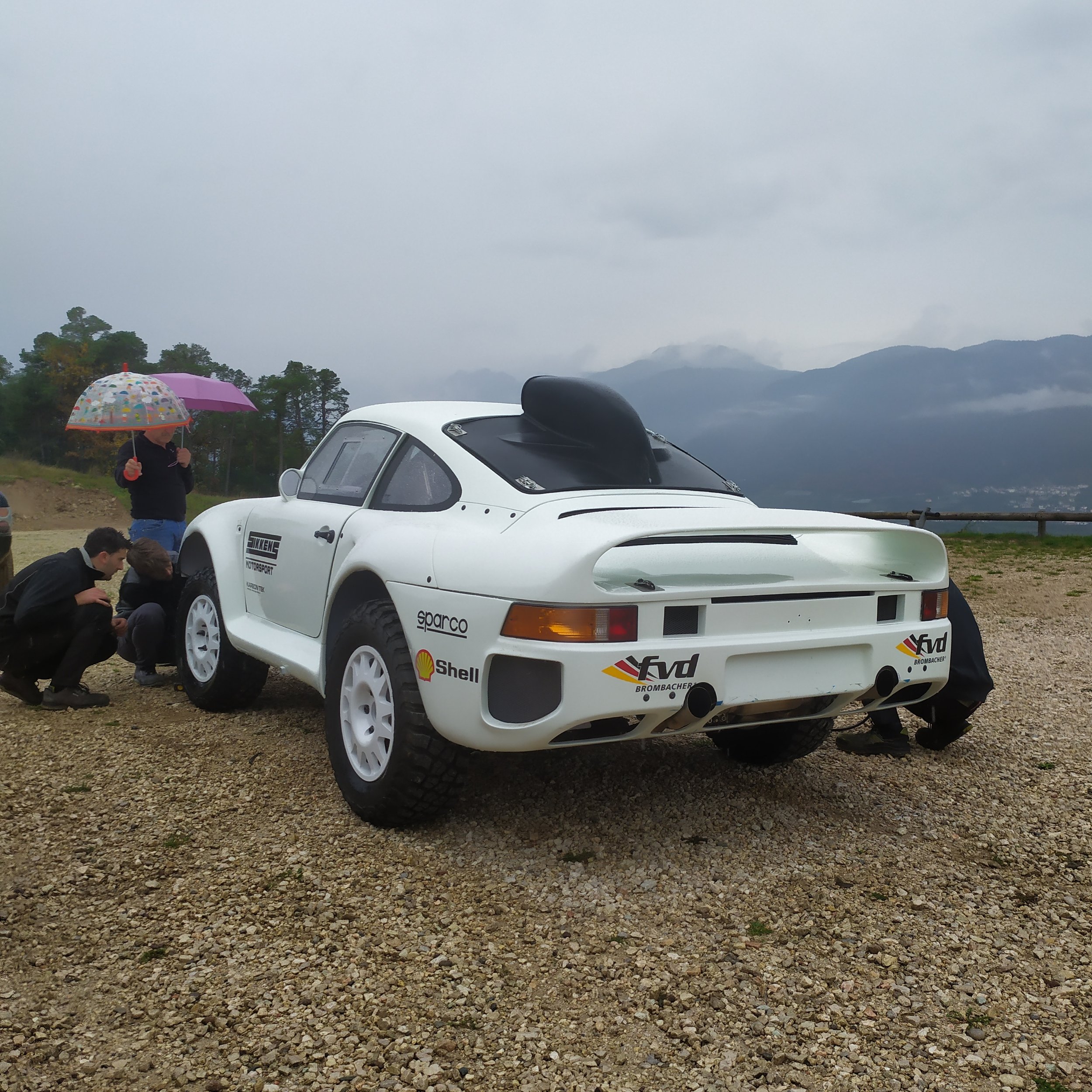 Sikkens Motorsport Dakar heritage project rally car parked during outdoor inspection in mountainous conditions