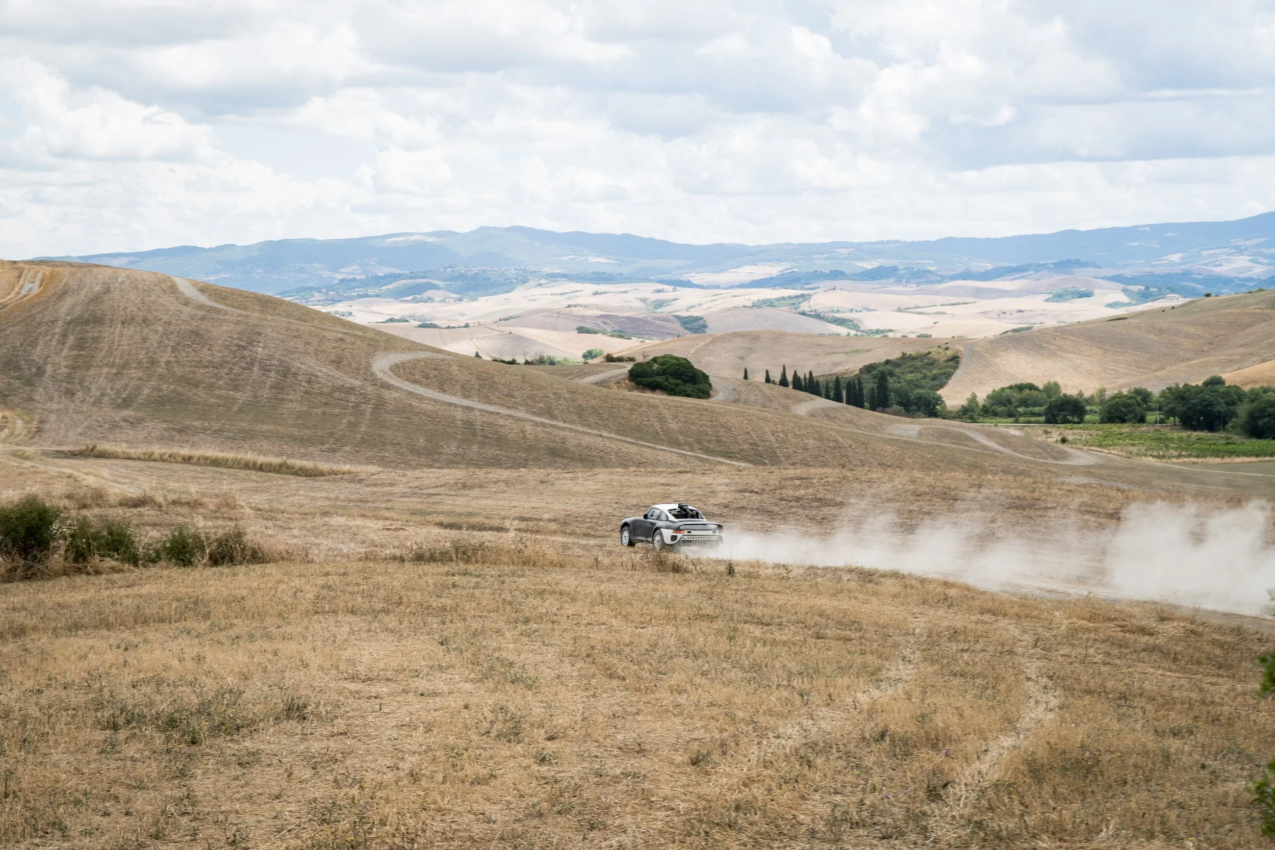 Sikkens Motorsport Dakar heritage project car driving on a gravel road during off-road testing