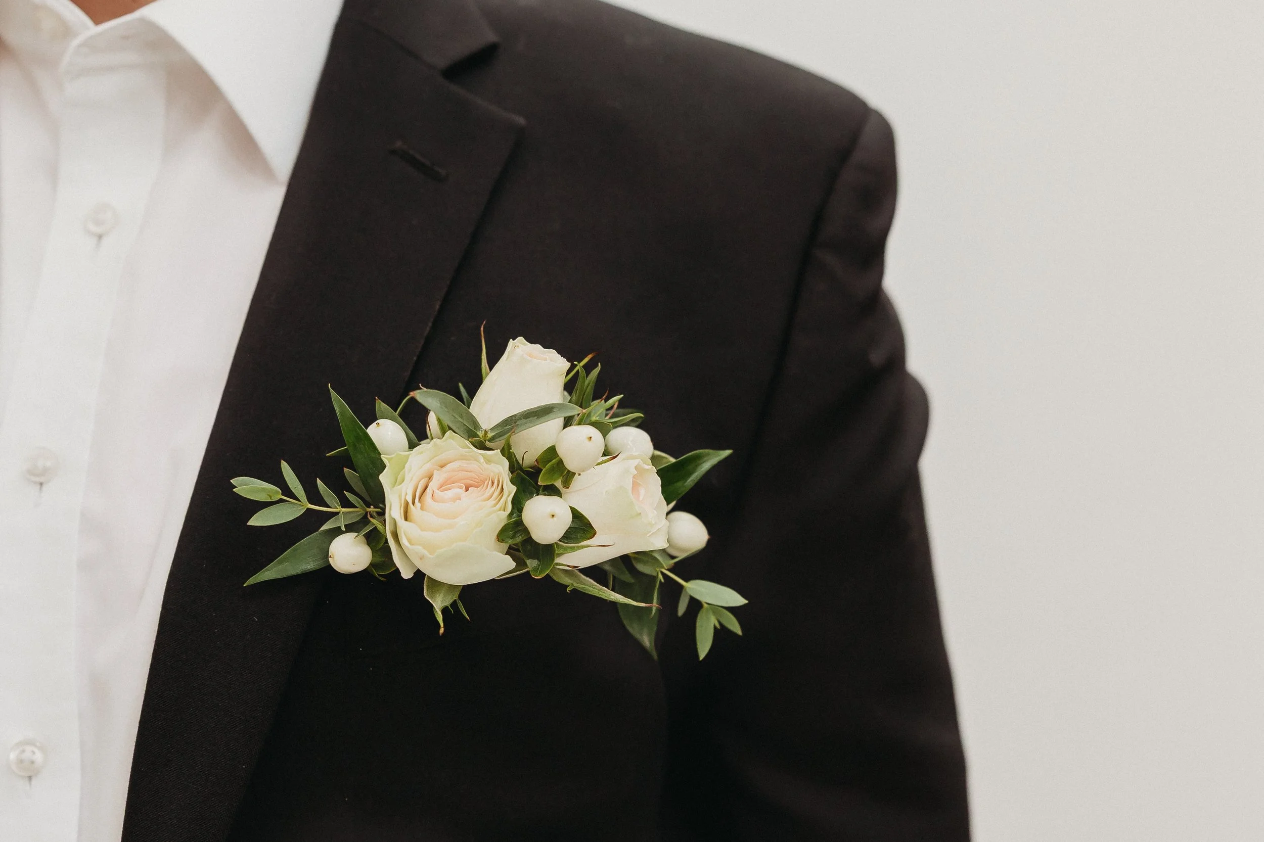 The Floratory's Cloud Nine collection with a neutral colored pocket boutonniere