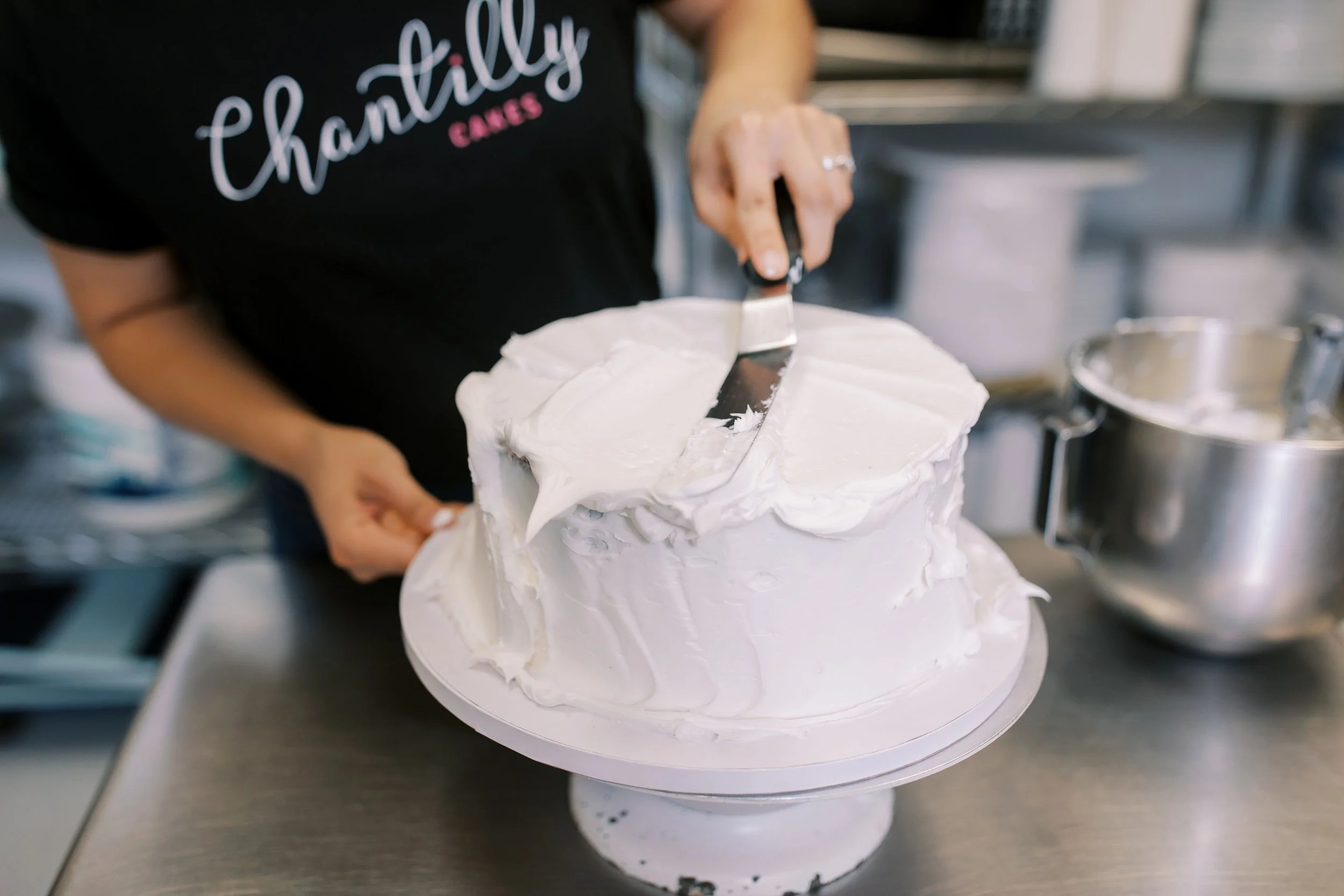 Decorating a cake covered in vanilla buttercream