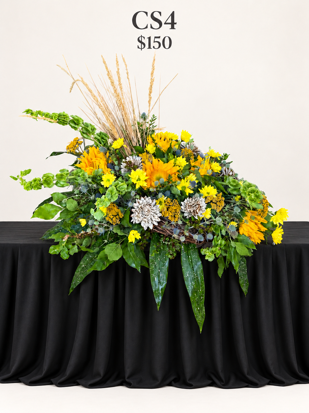 Floral arrangement on a wide black table.png