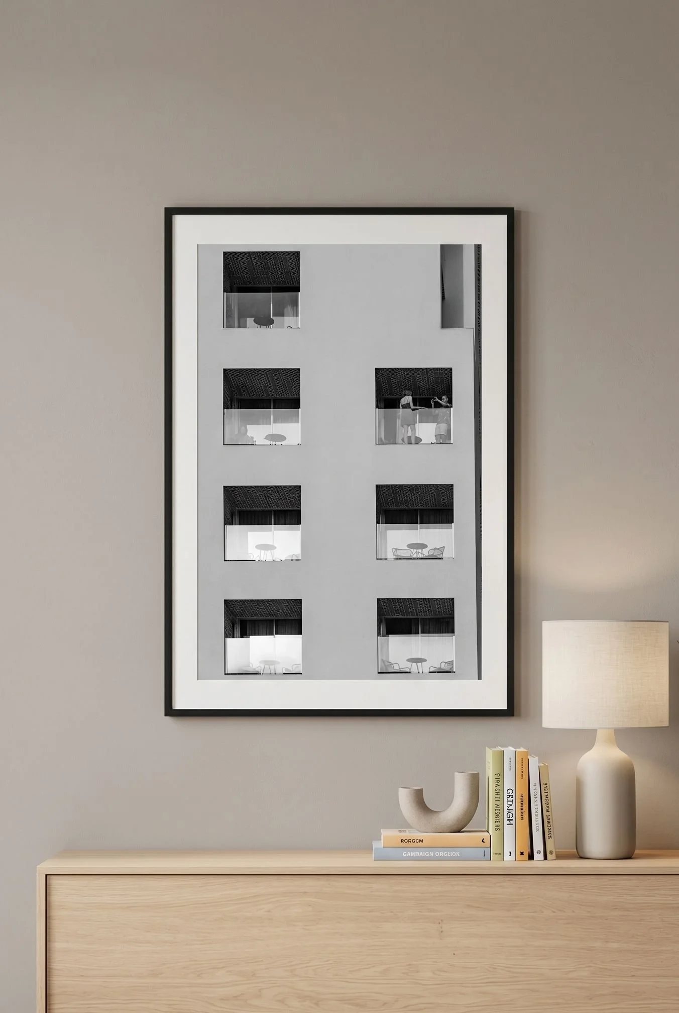 Hotel window grid print in a black frame above a minimal grey console.