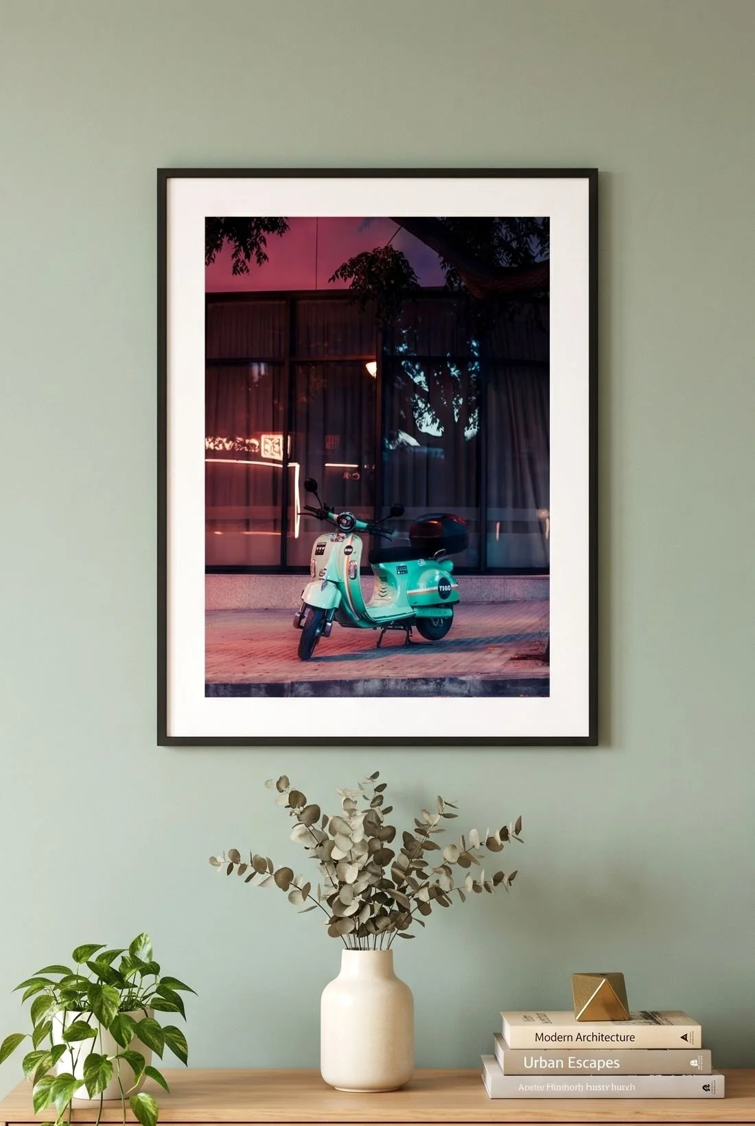 Turquoise Vespa print on a sage-green wall above a sideboard at blue hour.
