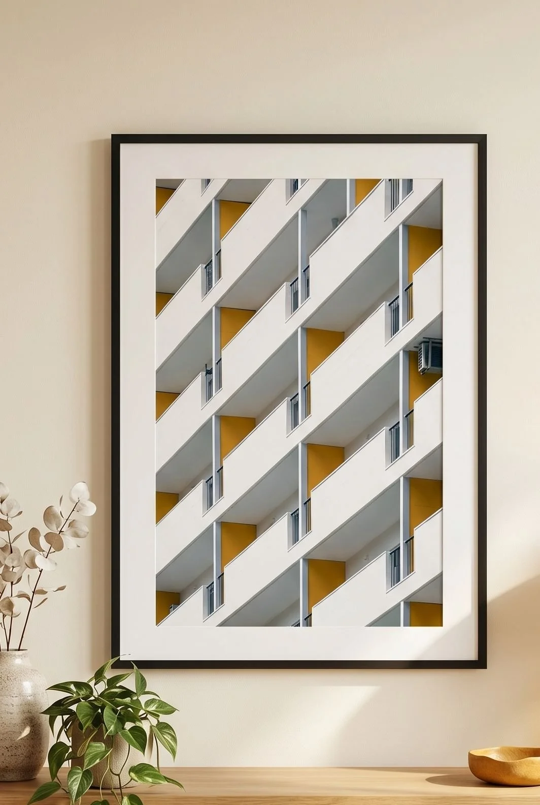 Tokyo architecture print in a black frame above a sofa with mustard cushions.