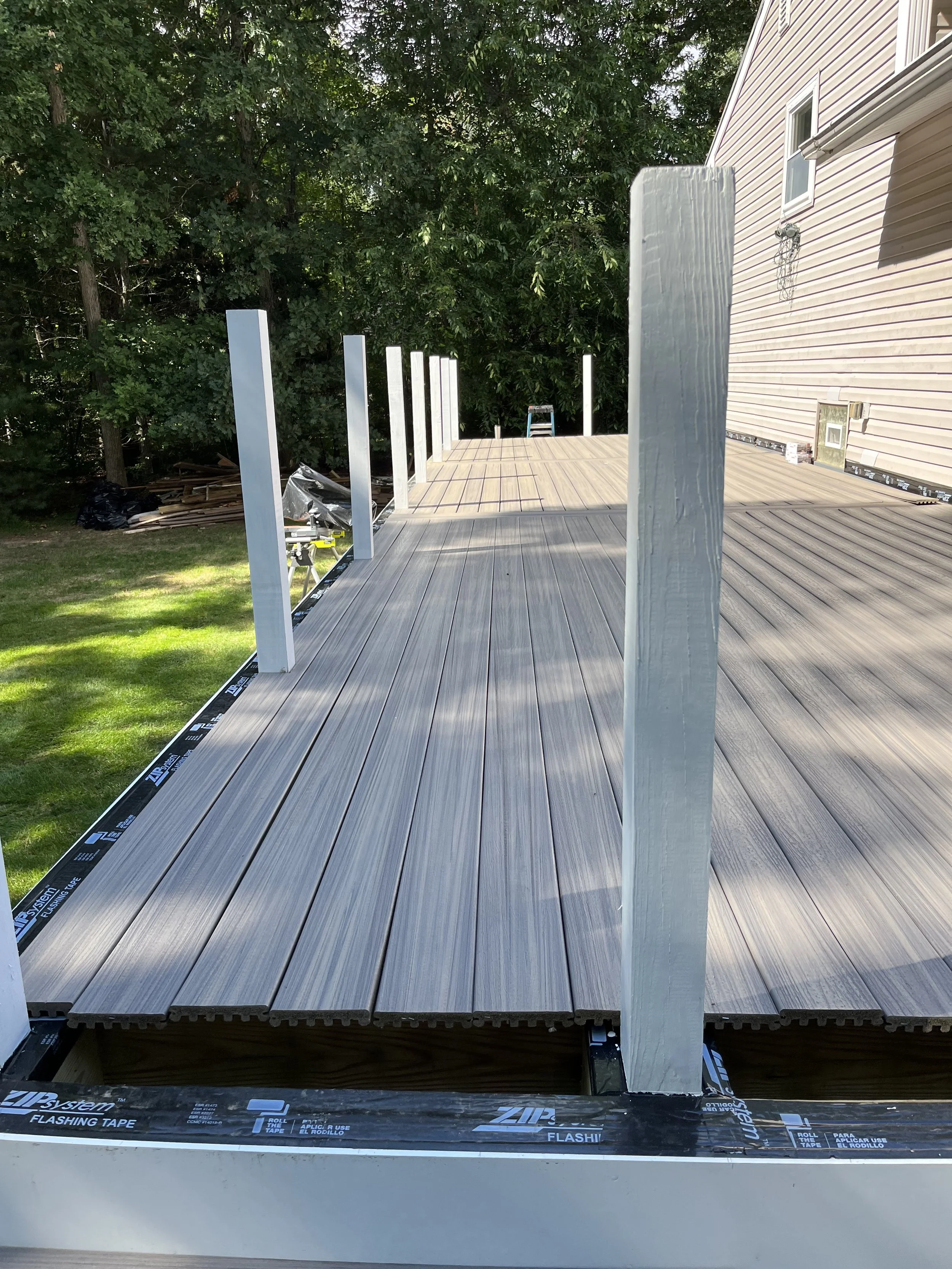 Construction of a raised composite deck with vertical support posts.