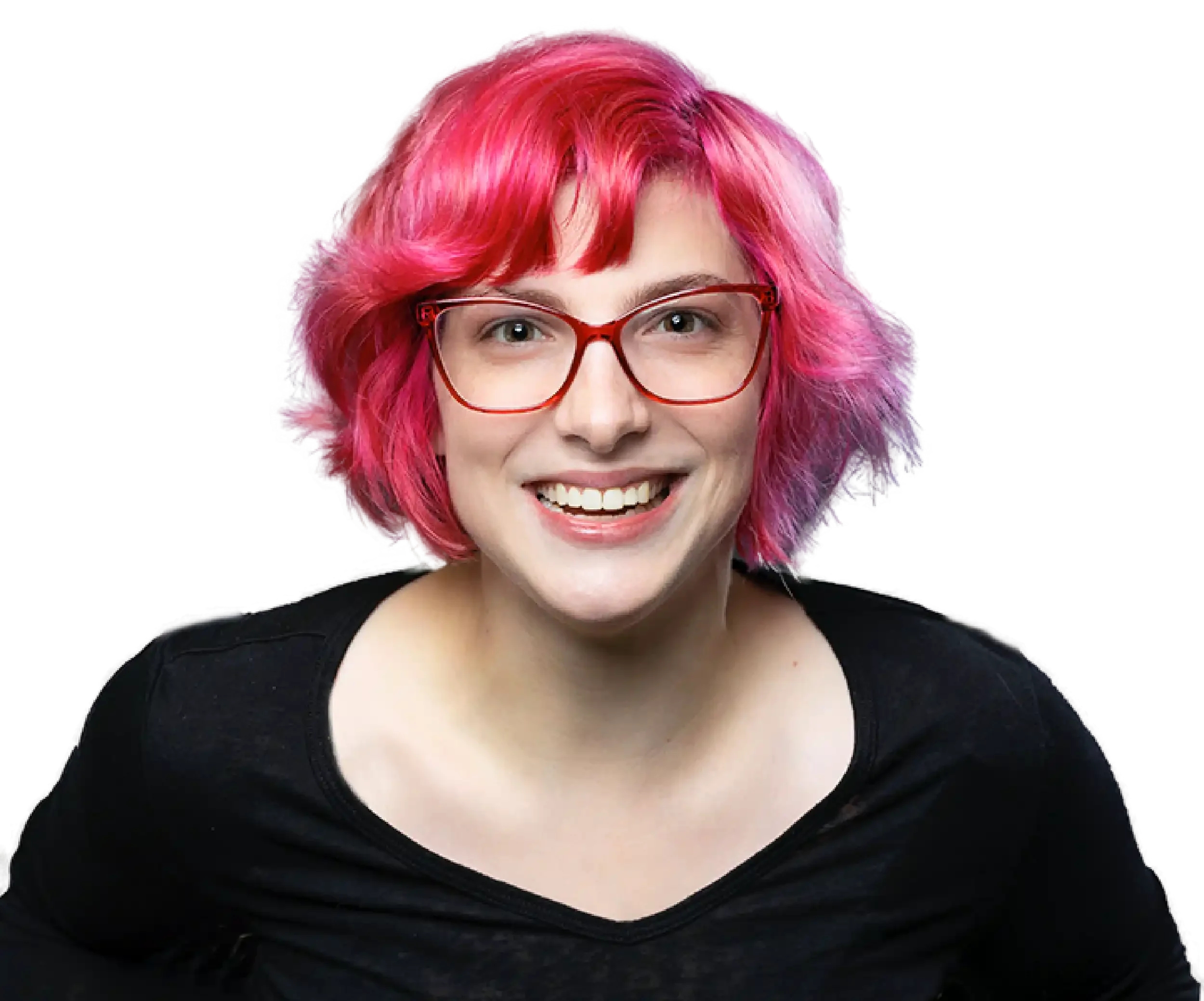 A woman with short curly pink hair, red glasses, and a big smile, wearing a black top, against a black background.