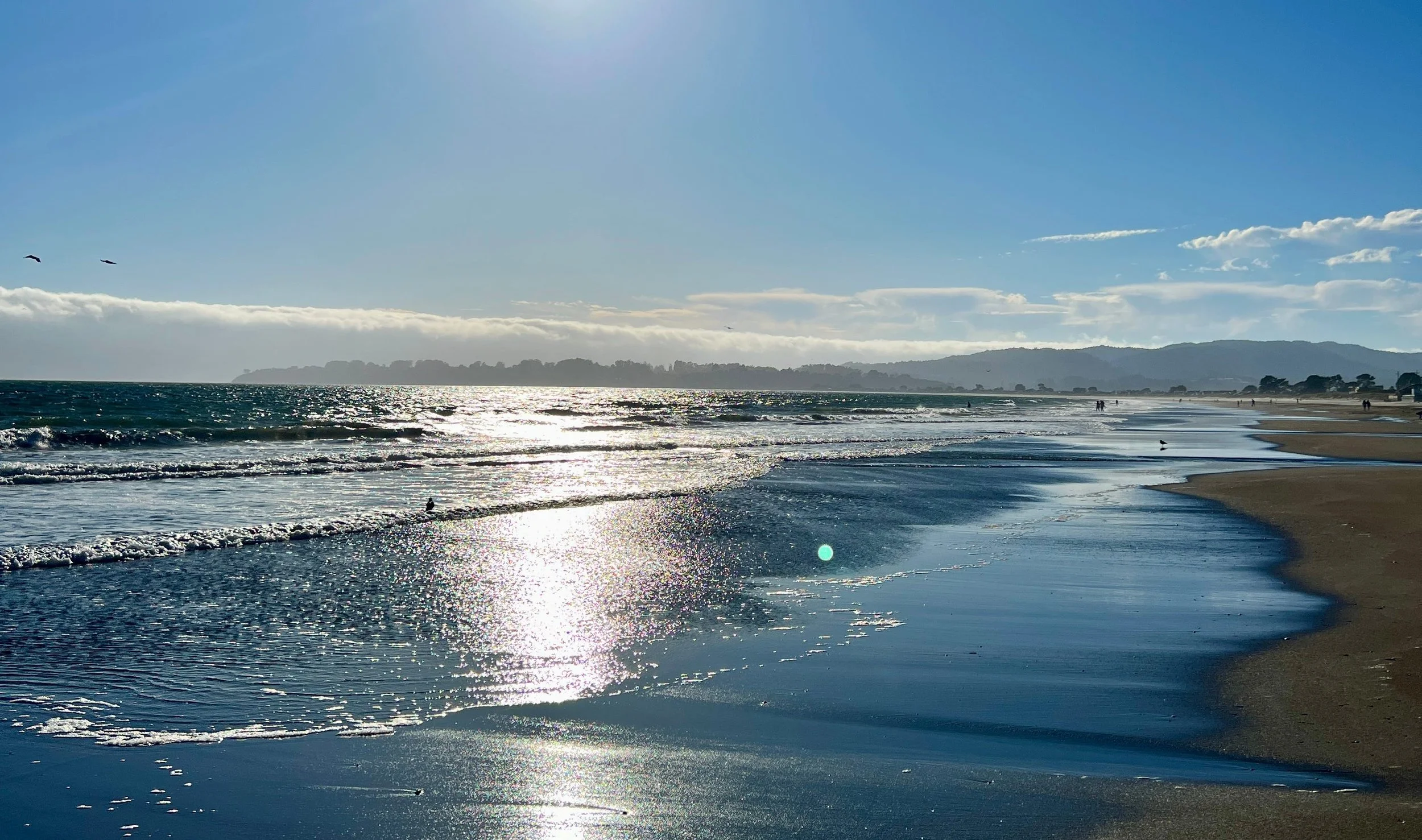 Tide going out on a sunny, clear day.