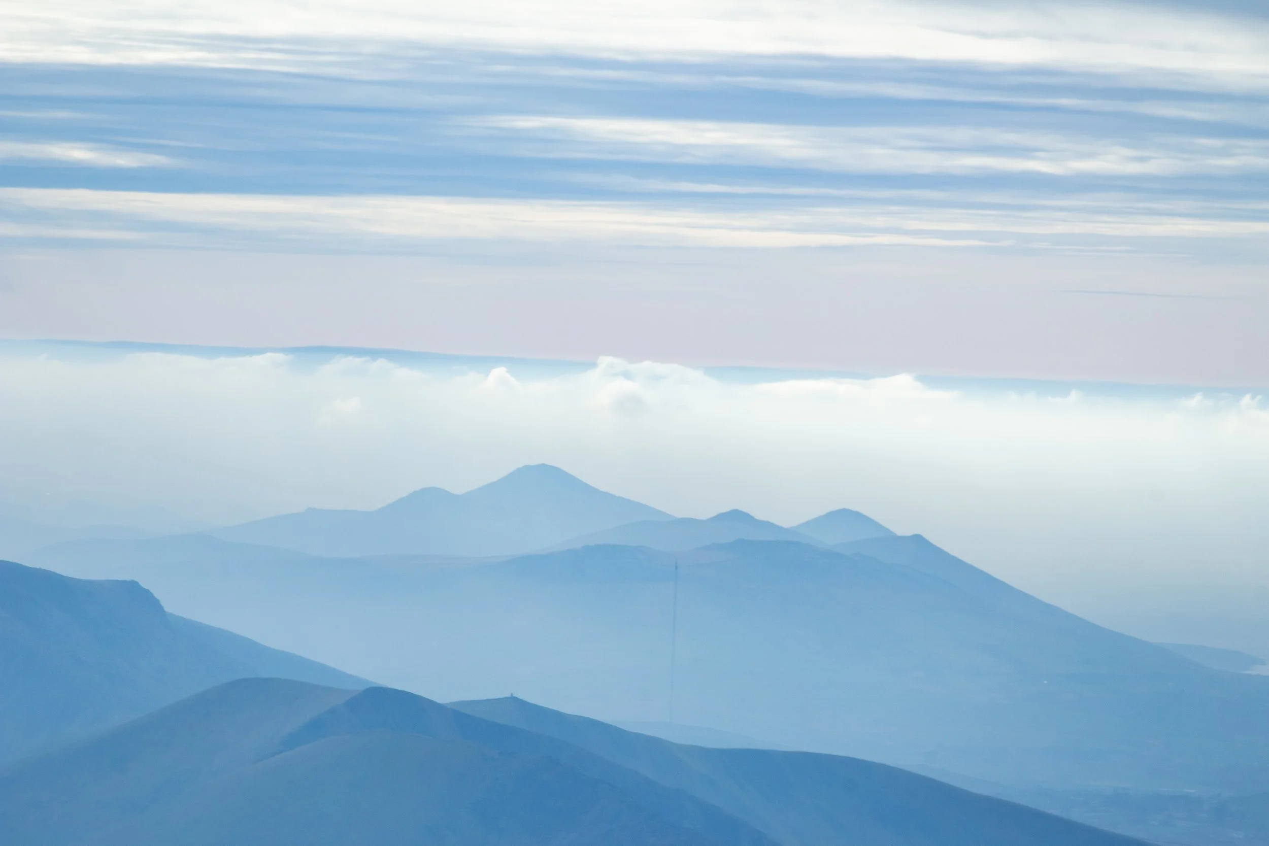 Scenic view of mountain range under partly cloudy sky