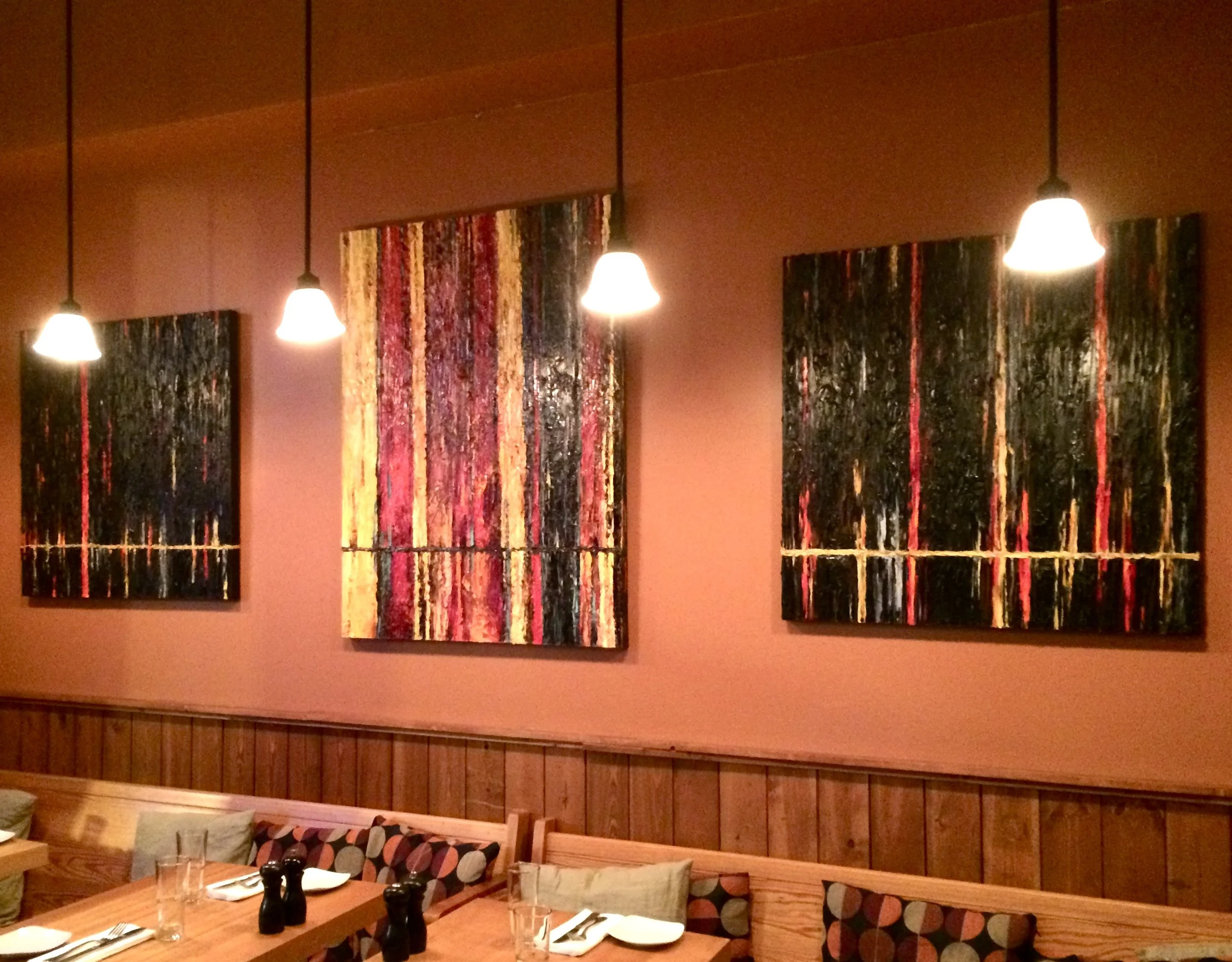 Three abstracts on display inside a Portland, Oregon restaurant