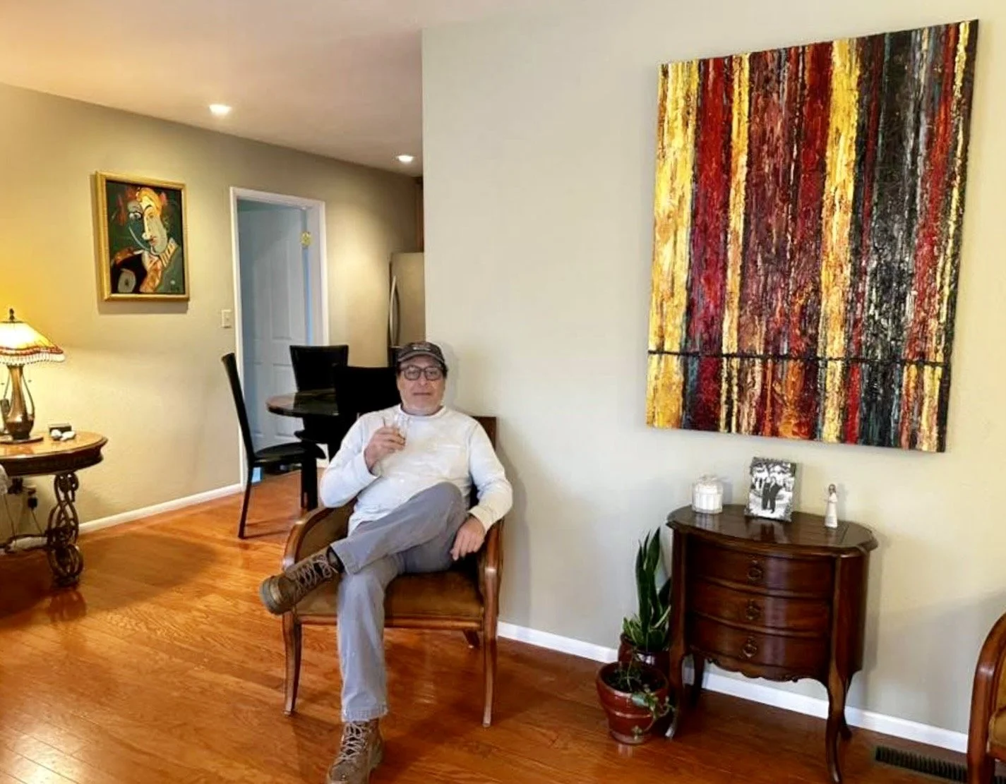 A Prescott, Arizona, client sipping his favorite beside the large abstract, "Black Forest."