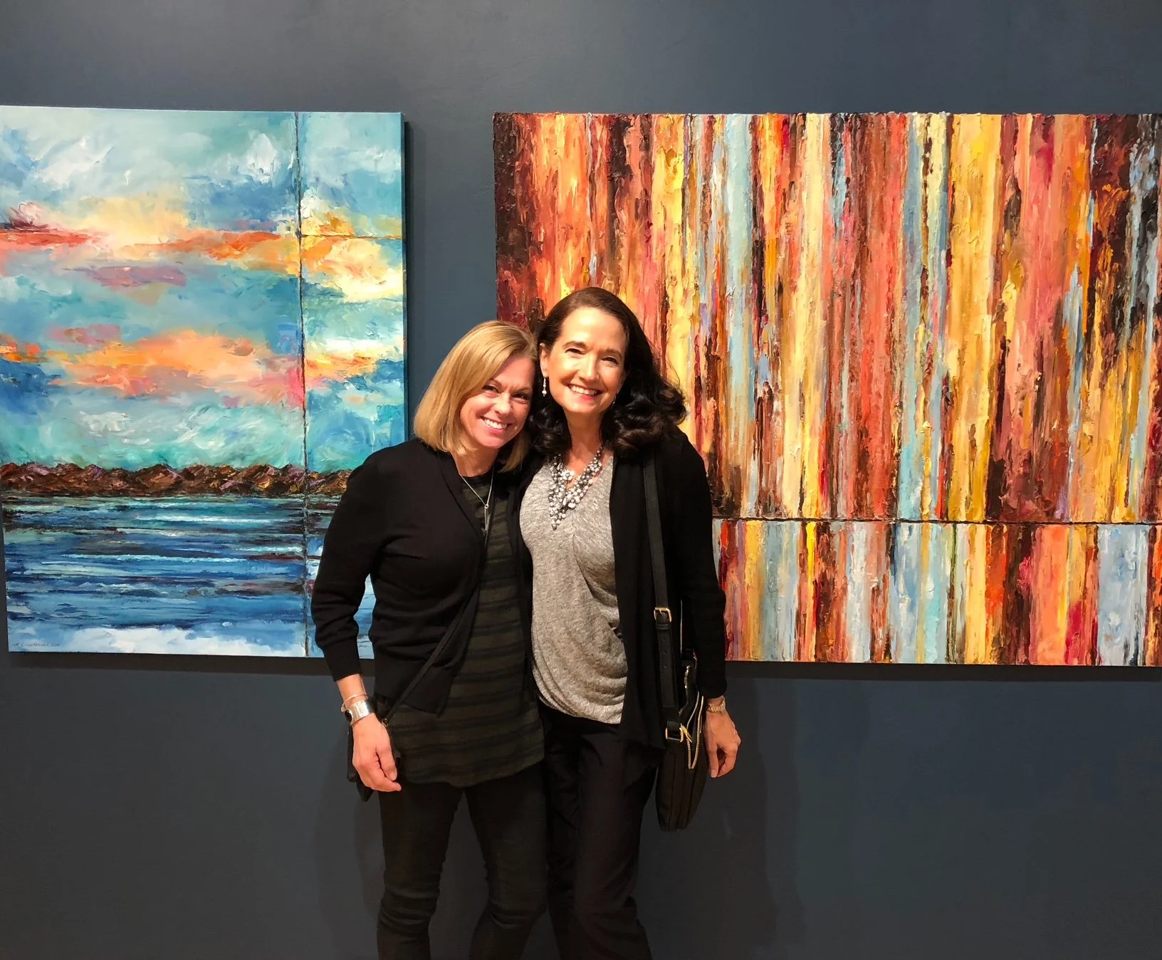 Karen and art lover in front of a pure abstract and abstracted landscape during solo show at Basic Space Gallery, Portland