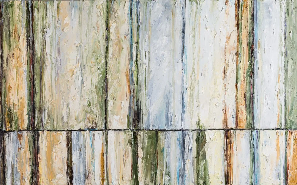 Close-up of weathered wooden planks with peeling paint in green, beige, and white colors.