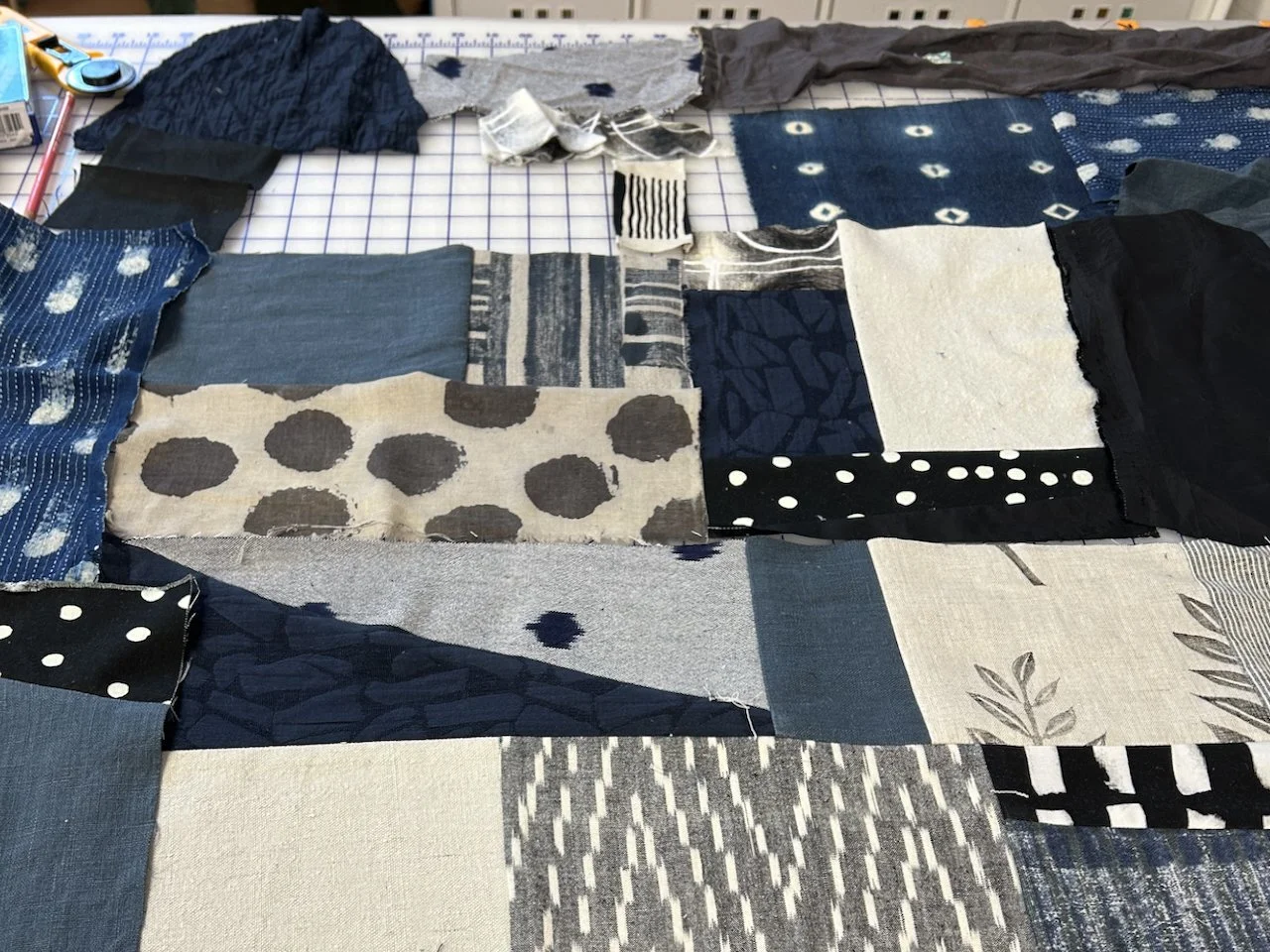 pieces of black white and blue fabric on a table