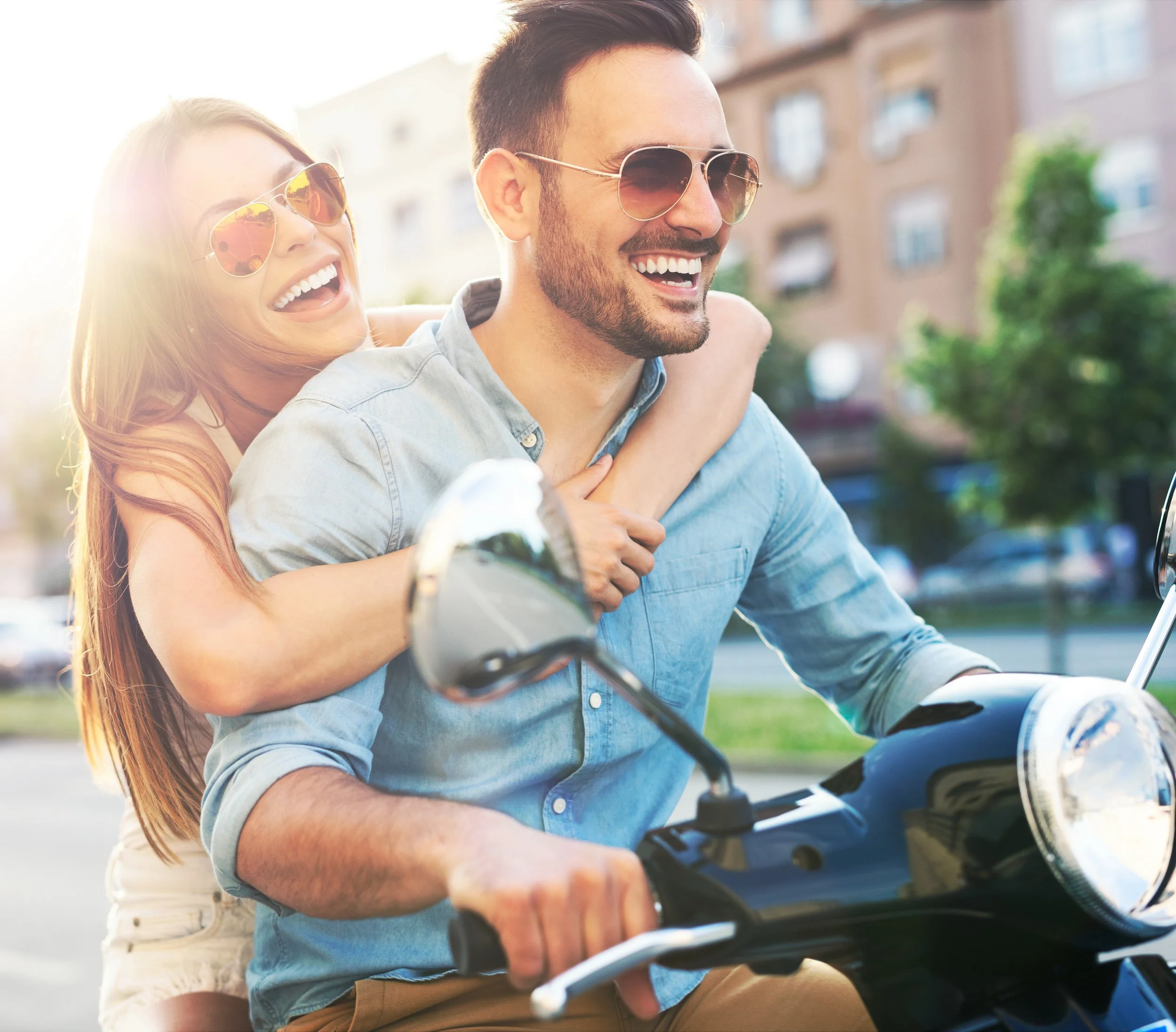 A happy couple on motorcyle, overlaid on commonly asked questions regarding telehealth and testosterone replacement therapy