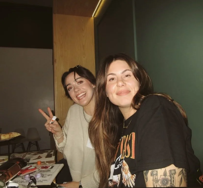 Two women smiling at Wingen Bakery for a Manifest Creative Club event, Collage and Cocktails. One is making a peace sign.