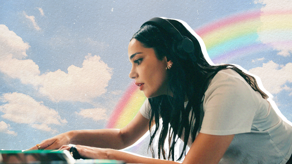 Woman with long dark hair and headphones DJing against sky background with clouds and rainbow