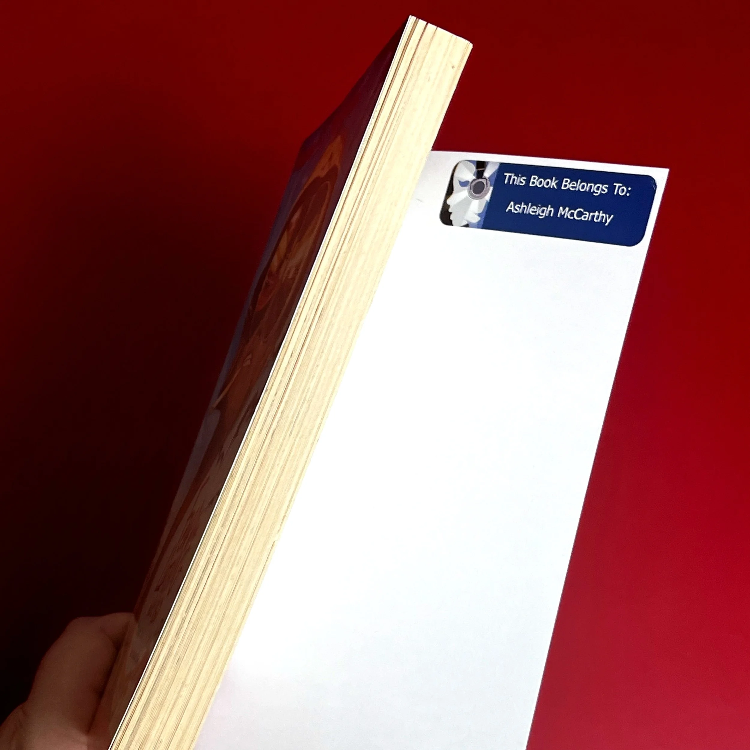 A blue sticker that reads "This Book Belongs to Ashleigh McCarthy": This is sticker is from a prior owner.