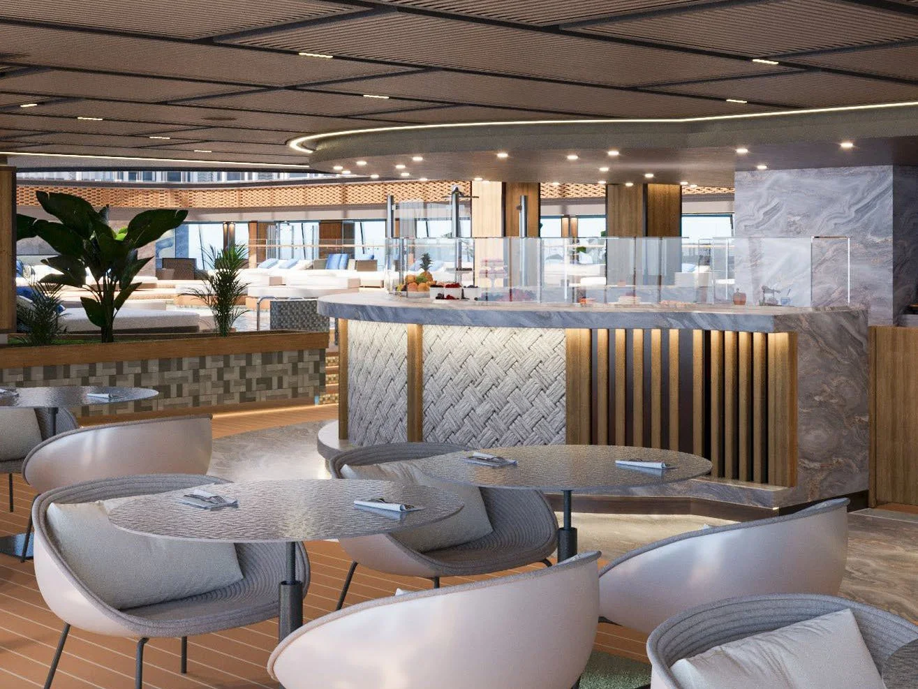 Modern indoor lounge with tables and chairs, plants, and a buffet area with desserts in the background.