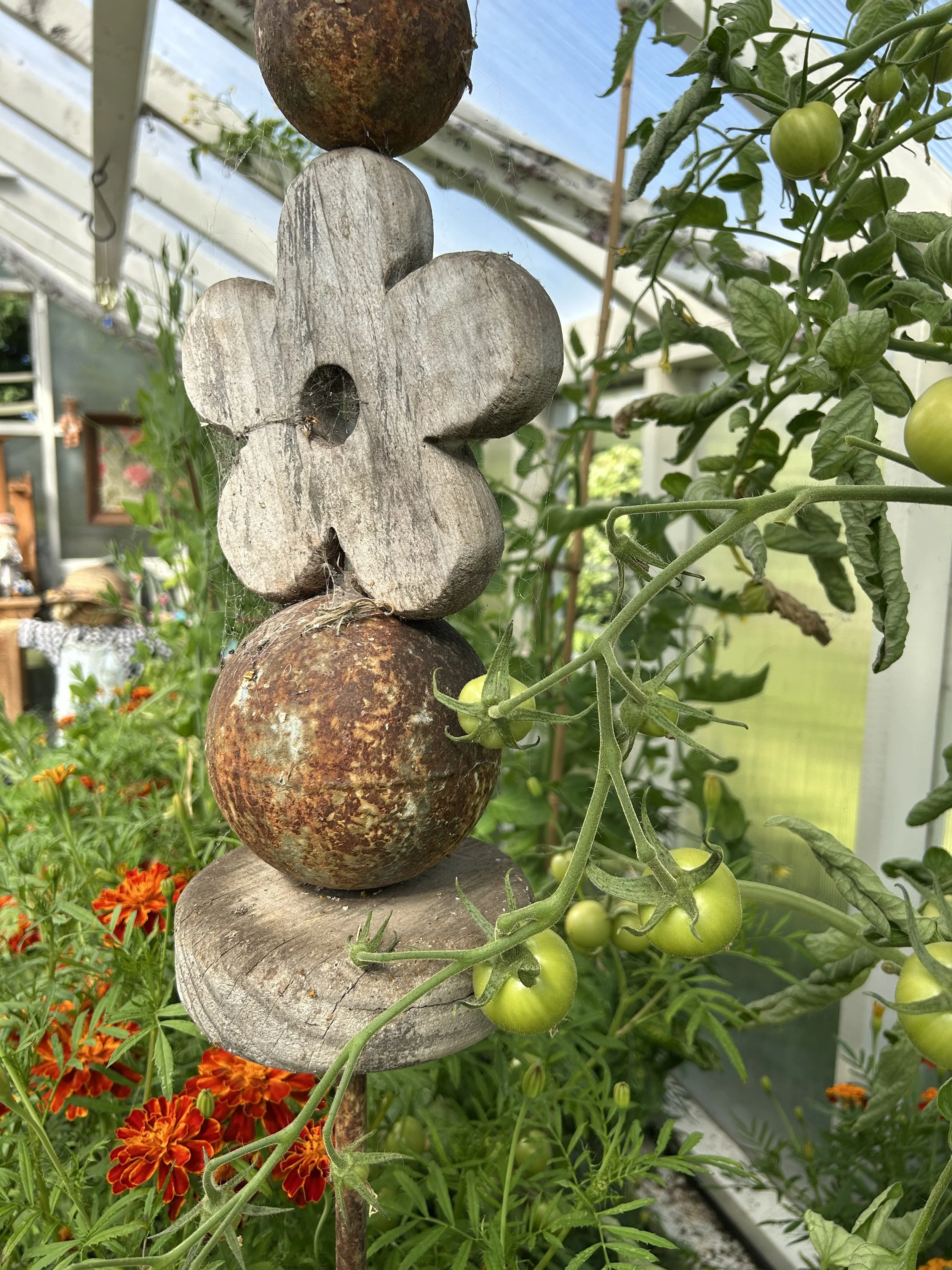 I love a bit of garden art that also has function.  This is a plant stake too.  