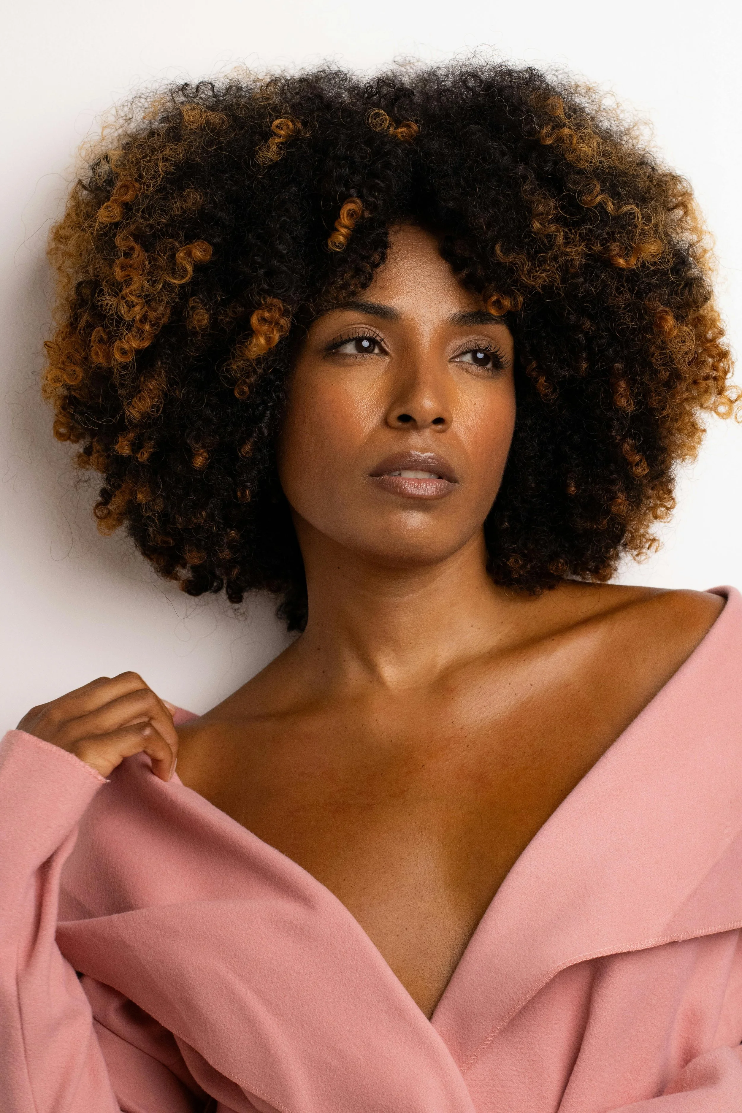 Confident woman with a thoughtful expression, representing independence and emotional self-reliance in relationships.