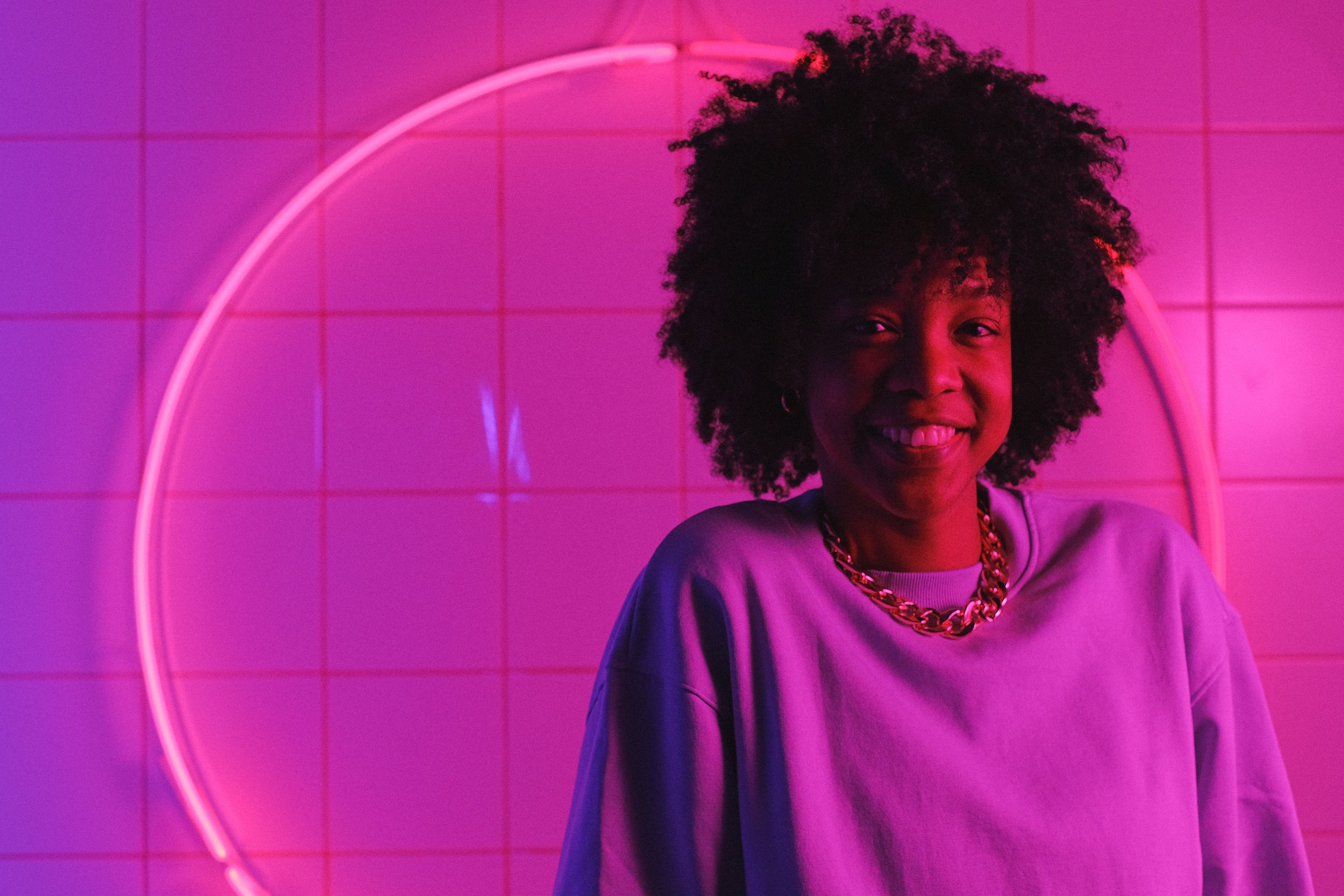 A smiling woman featured in a blog post about avoidant attachment, hyper-independence, and emotional vulnerability.