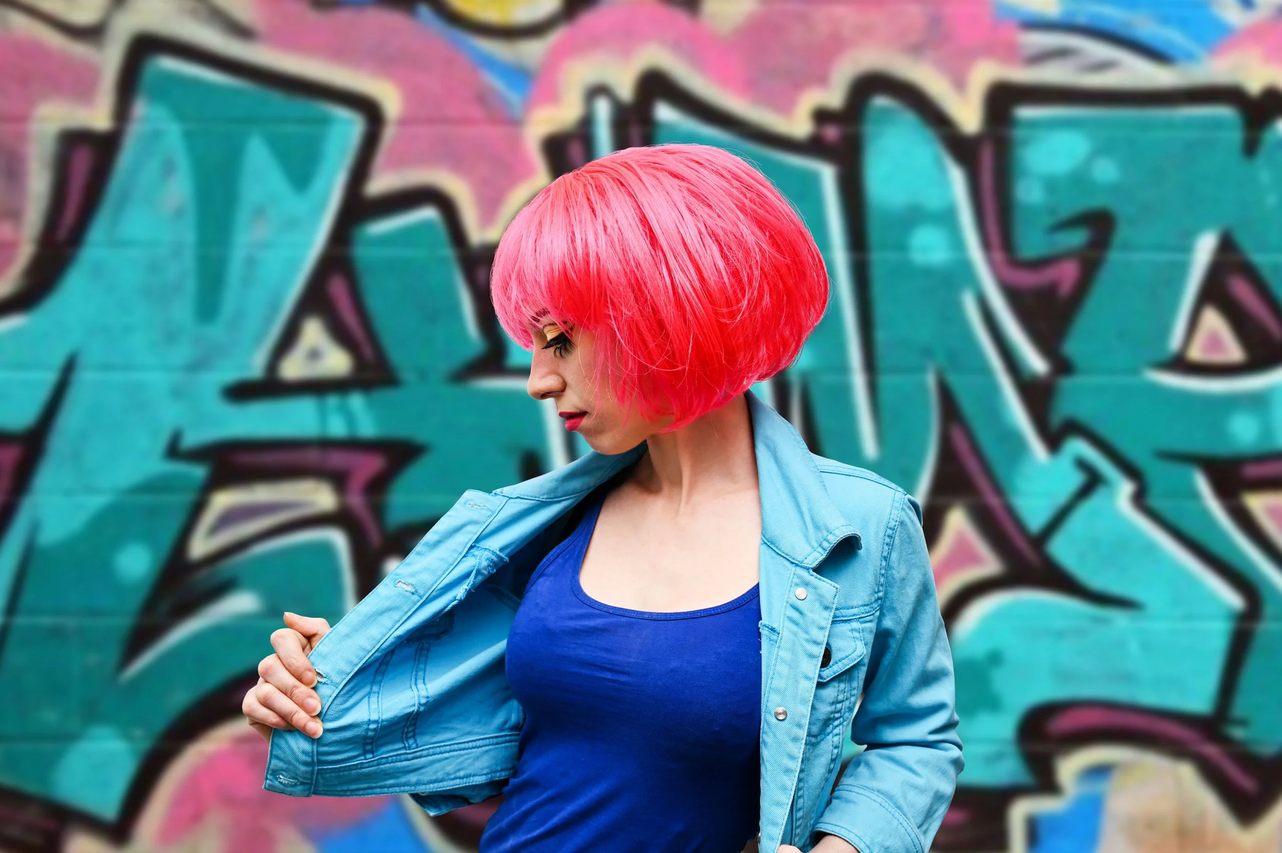 A woman with vibrant pink hair wearing a denim jacket, symbolizing the strength and hyper-independence of women healing from attachment wounds and narcissistic abuse.