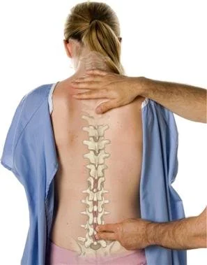 Person with back pain receiving spinal manipulation therapy