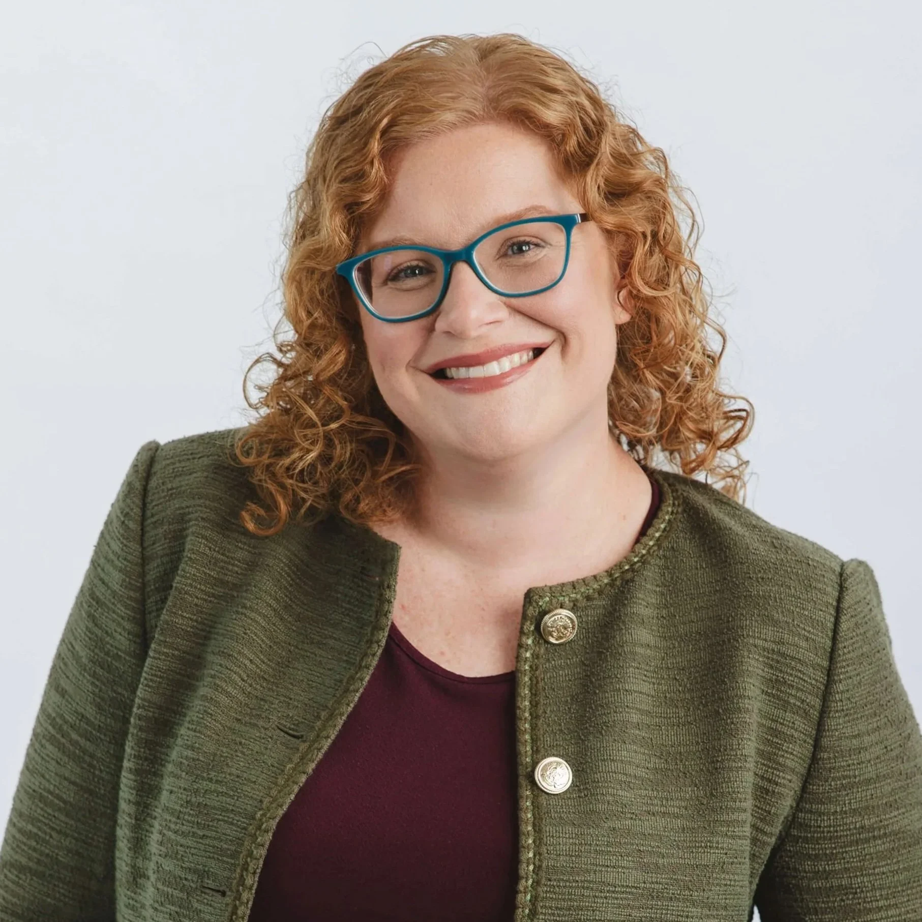 Amanda Forr of Relay Community Benefit Solutions is smiling in front of a plain white background.
