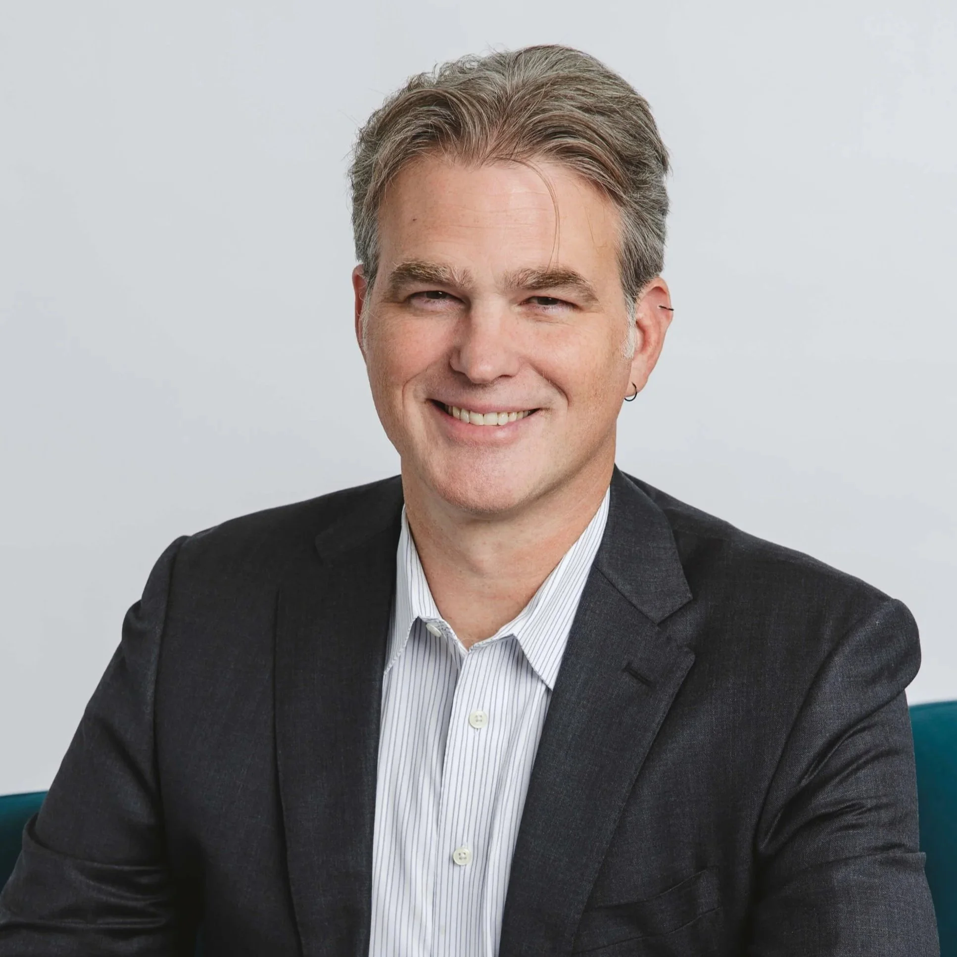 Justin Colbert of Relay Community Benefit Solutions is smiling at the camera.