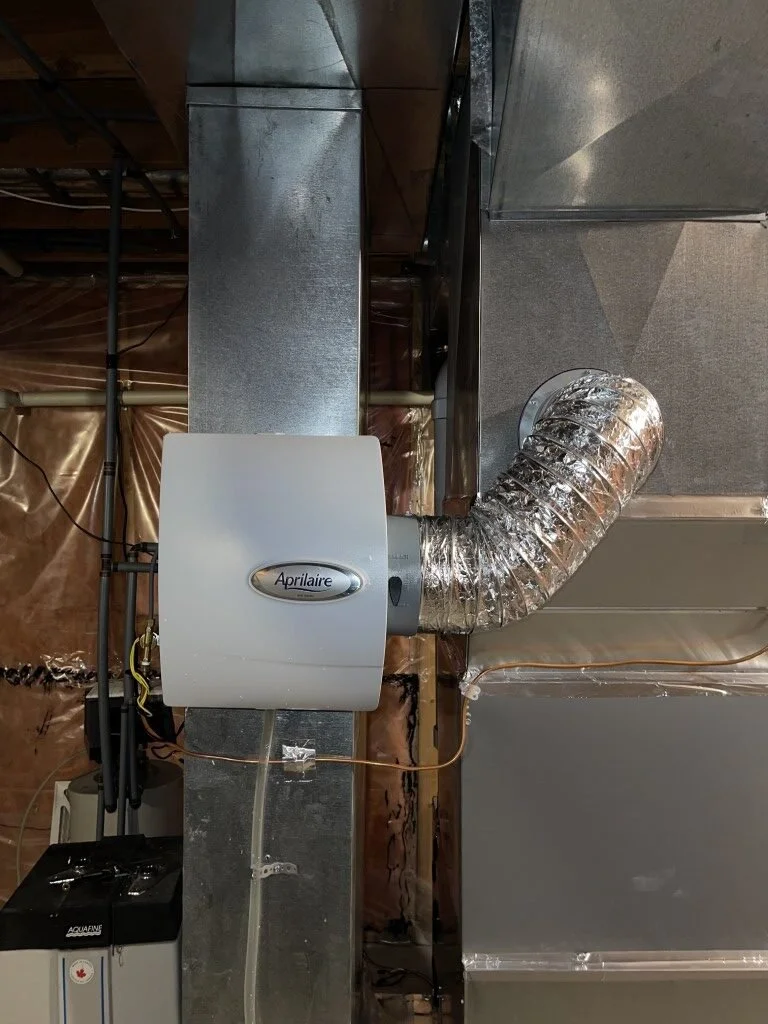 A furnace or HVAC system ductwork and vent in a building basement or utility area.