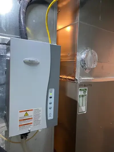 Electrical panel and ductwork in a building utility room.