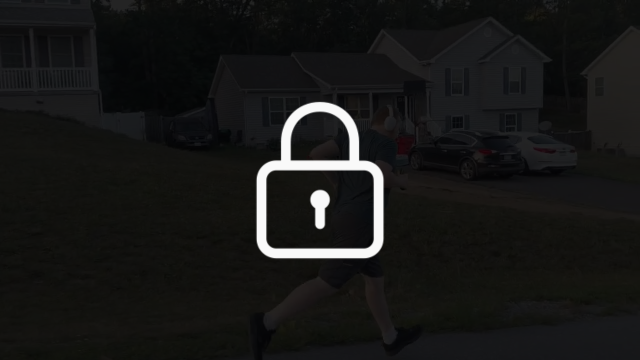 A locked image of Ultra Week Co-Founder, Landon Lesser, running on the side of the road, passing a house