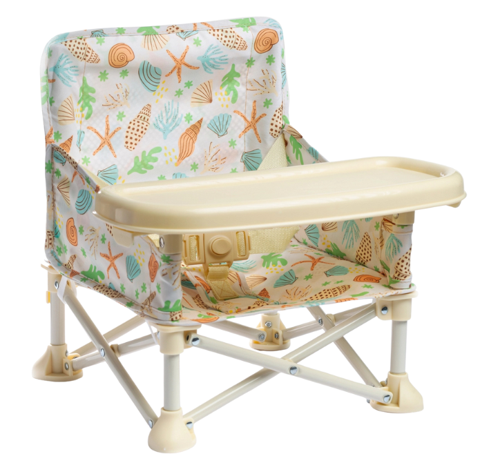 A baby beach chair with a colorful fabric cover featuring sea shells, starfish, and seaweed designs. It has a beige plastic tray and a sturdy white metal frame.
