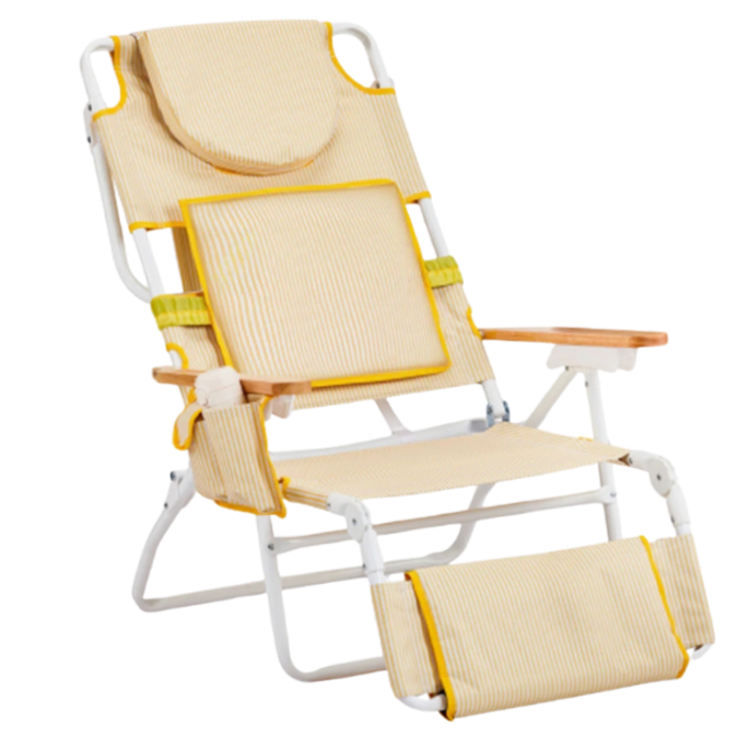 A striped yellow adjustable beach lounge chair with a footrest, face and arm holdes, and padded seat.