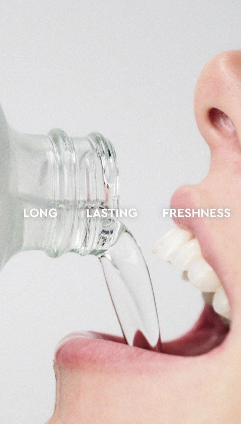 Close-up of a person drinking water from a clear glass bottle, with words 'LONG LASTING FRESHNESS' overlaid on the image.