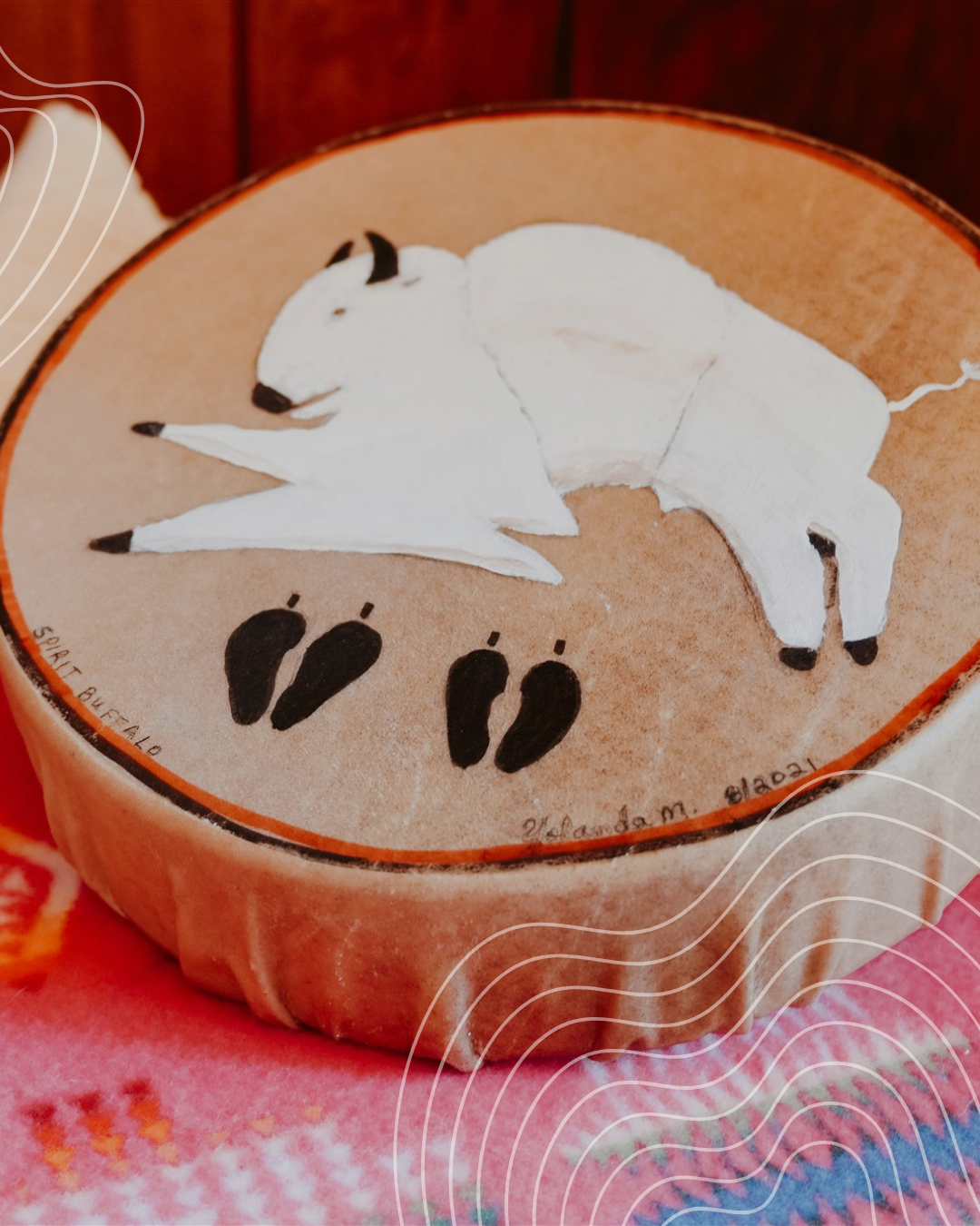 Round ceramic container with a painted image of a lying white dog with black ears and tail, surrounded by black paw prints.