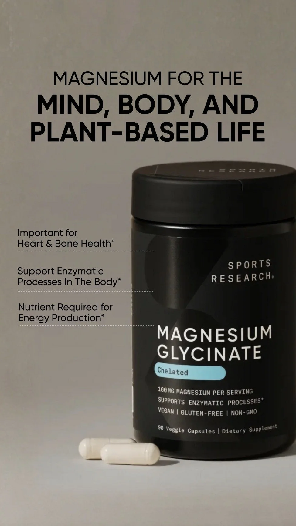 A container of sports research magnesium glycinate supplement with two white capsules in front.