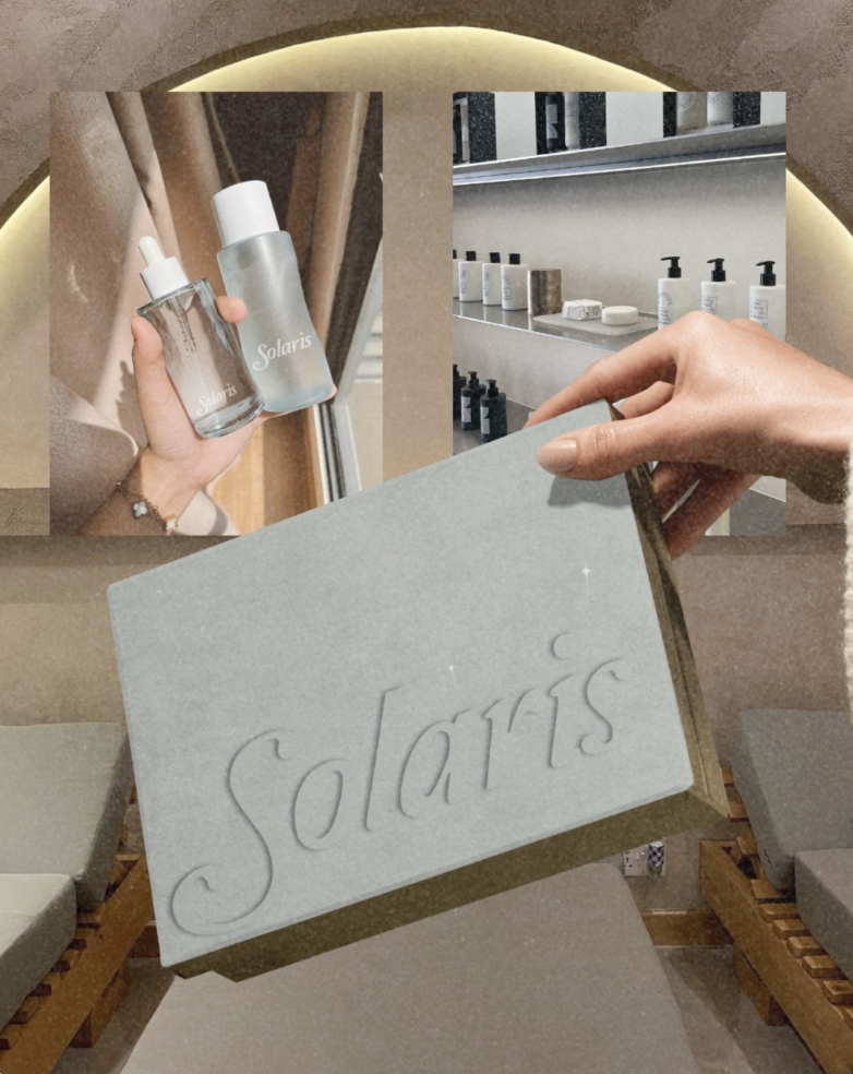 A hand holding a Solaris branded box, with a mirror beside it. In the background, a mirror and shelves display various skincare or beauty products in a modern, minimalistic setting.