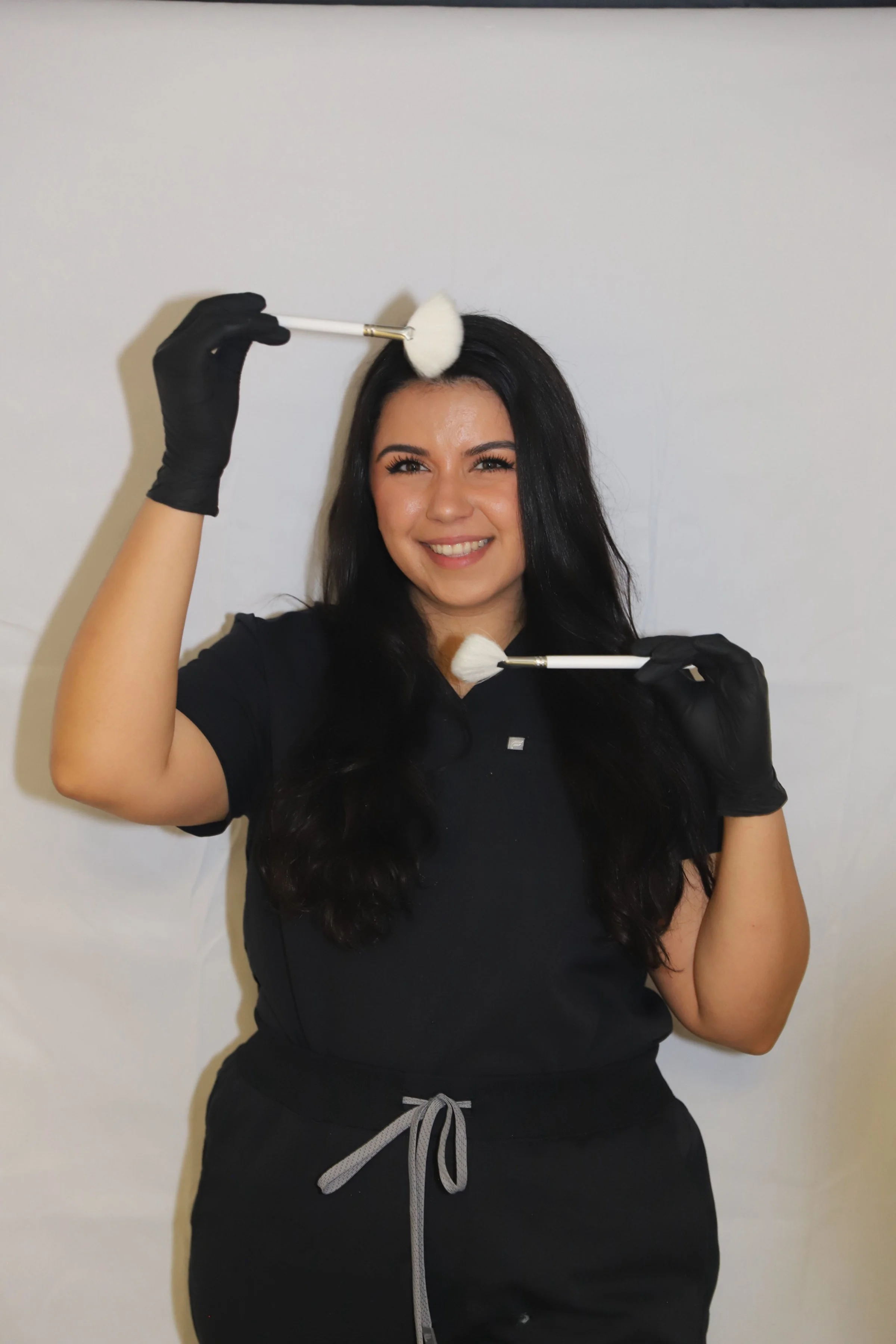 Professional facial esthetician in San Dimas using fan brushes for customized skincare treatments and glowing results