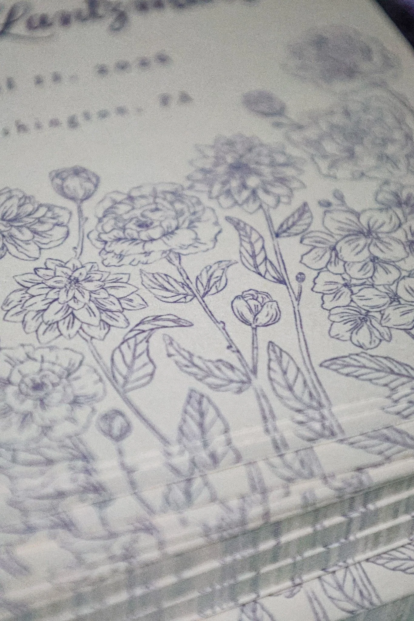Close-up of a printed save the date card with vintage ink drawings of various flowers and leaves.