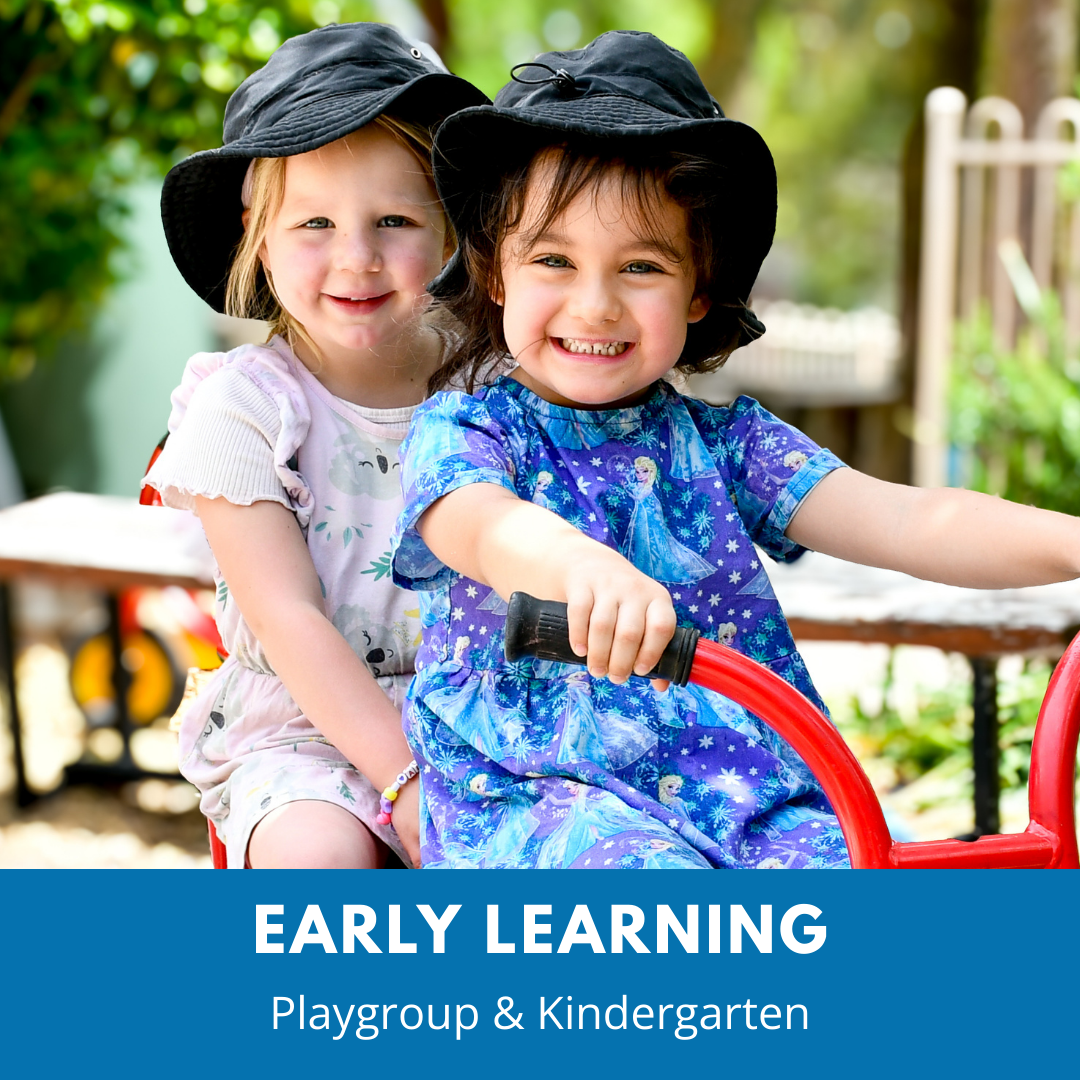 Two pre-school aged girls on tricycle. There is a blue banner at the base of the image that reads Early Leaning - Playgroup & Kindergarten