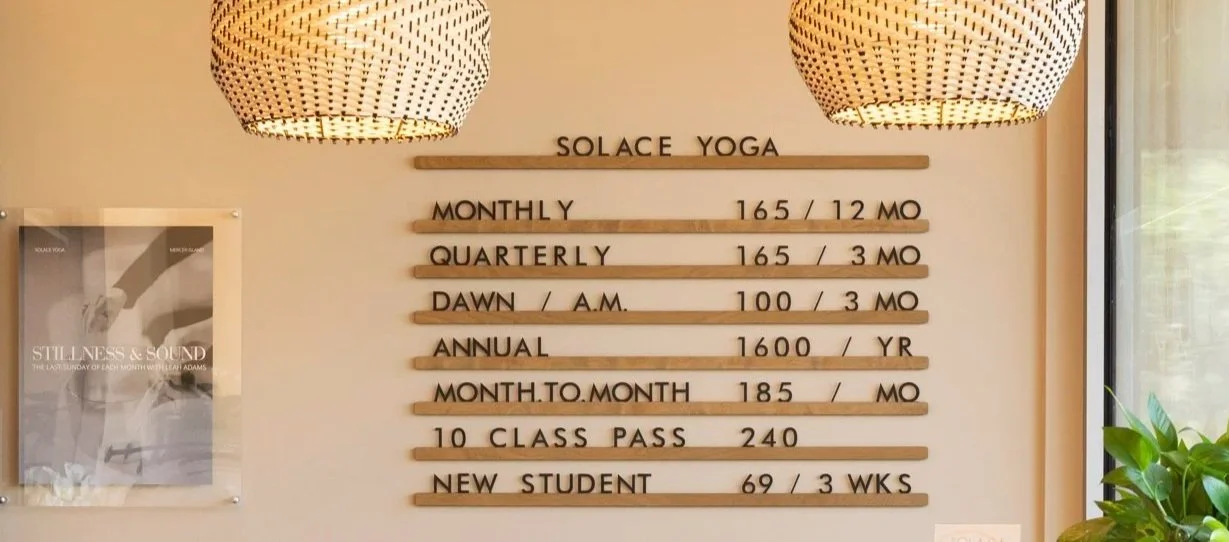 The pricing board on the wall at Solace Yoga